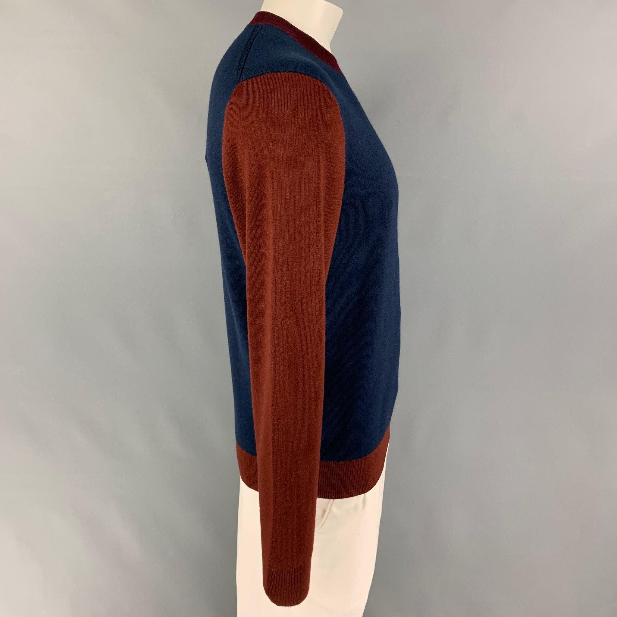 PAUL SMITH sweater comes in a navy & burgundy color block merino wool featuring a crew-neck.
Very Good
Pre-Owned Condition. 

Marked:   L  

Measurements: 
 
Shoulder:
19 inches Chest: 42 inches Sleeve: 27 inches Length: 26.5 inches 
  
  
