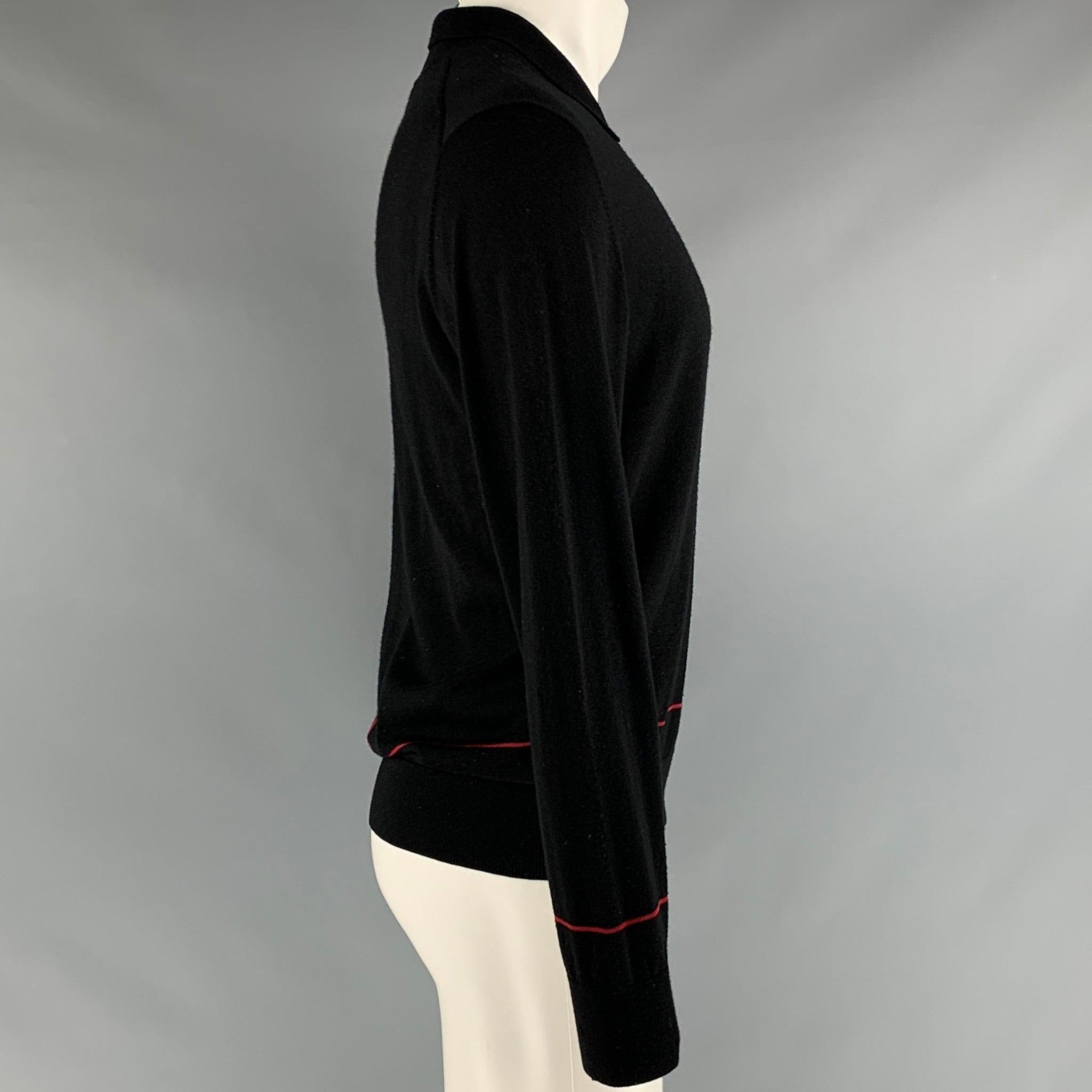 PS by PAUL SMITH pullover in a black merino wool featuring red stripe detail, spread collar, and half placket button closure.Good Pre-Owned Condition. Moderate signs of wear, please check photos. As is. 

Marked:   S 

Measurements: 
 
Shoulder: 18