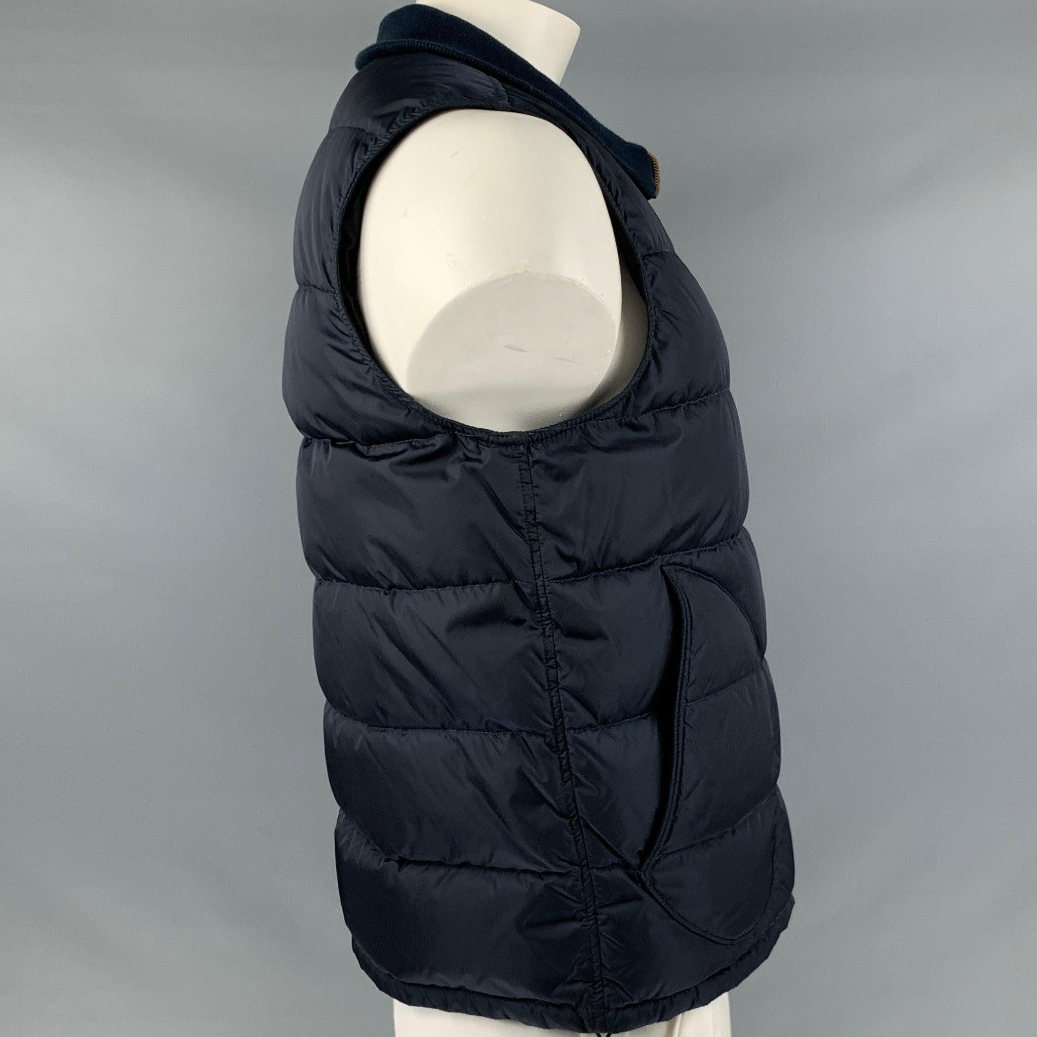 PAUL SMITH vest in a navy nylon fabric featuring a quilted style, two pockets, and zip up closure.Excellent Pre-Owned Condition. 

Marked:   XL 

Measurements: 
 
Shoulder: 16 inches Chest: 44 inches Length: 25.5 inches 
  
  
 
Reference: