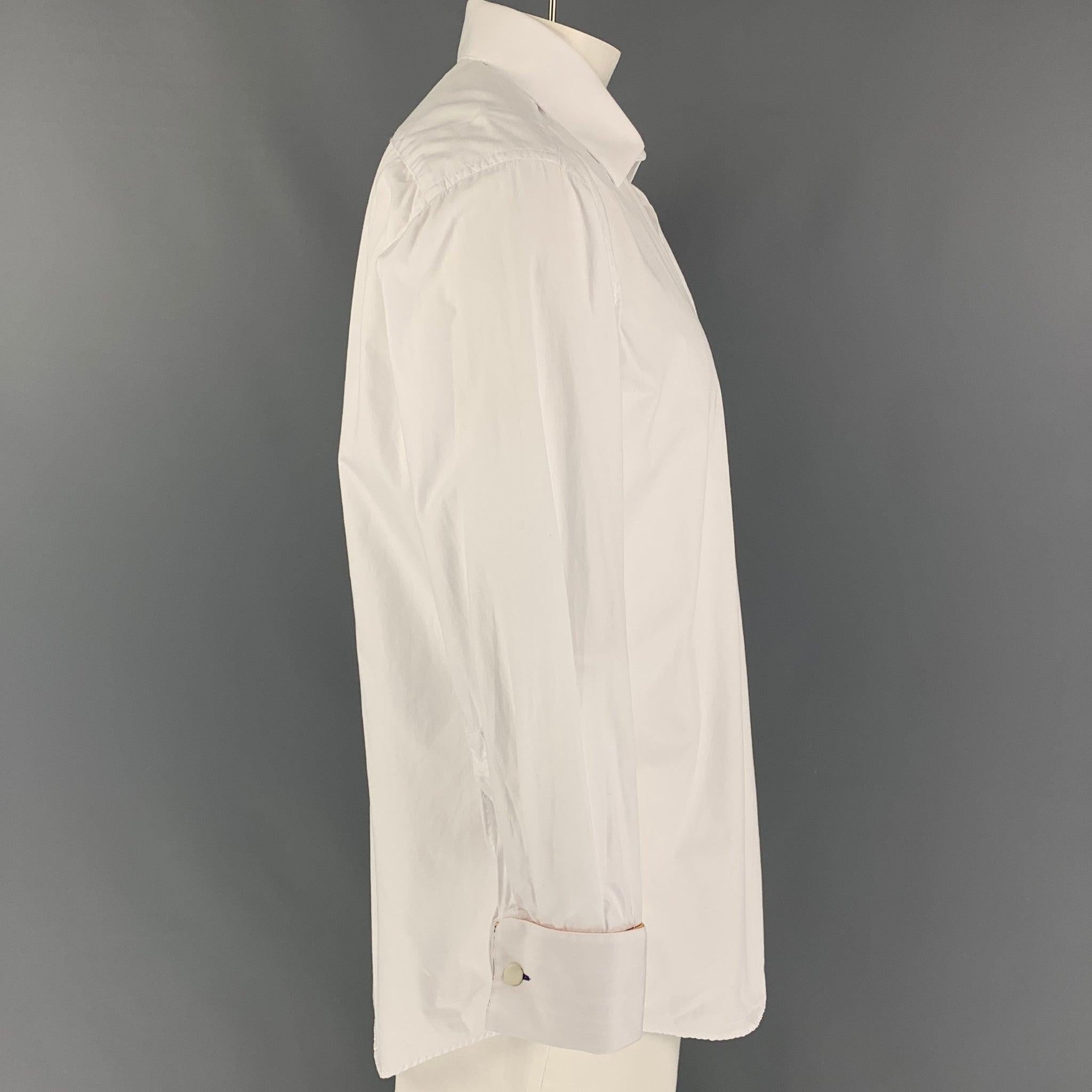 PAUL SMITH long sleeve shirt comes in a white cotton featuring a patch pocket, spread collar, french cuffs, and a button up closure. Doesn't include cufflinks. Made in Italy.
Very Good
Pre-Owned Condition. 

Marked:   17.5/44 

Measurements: 
