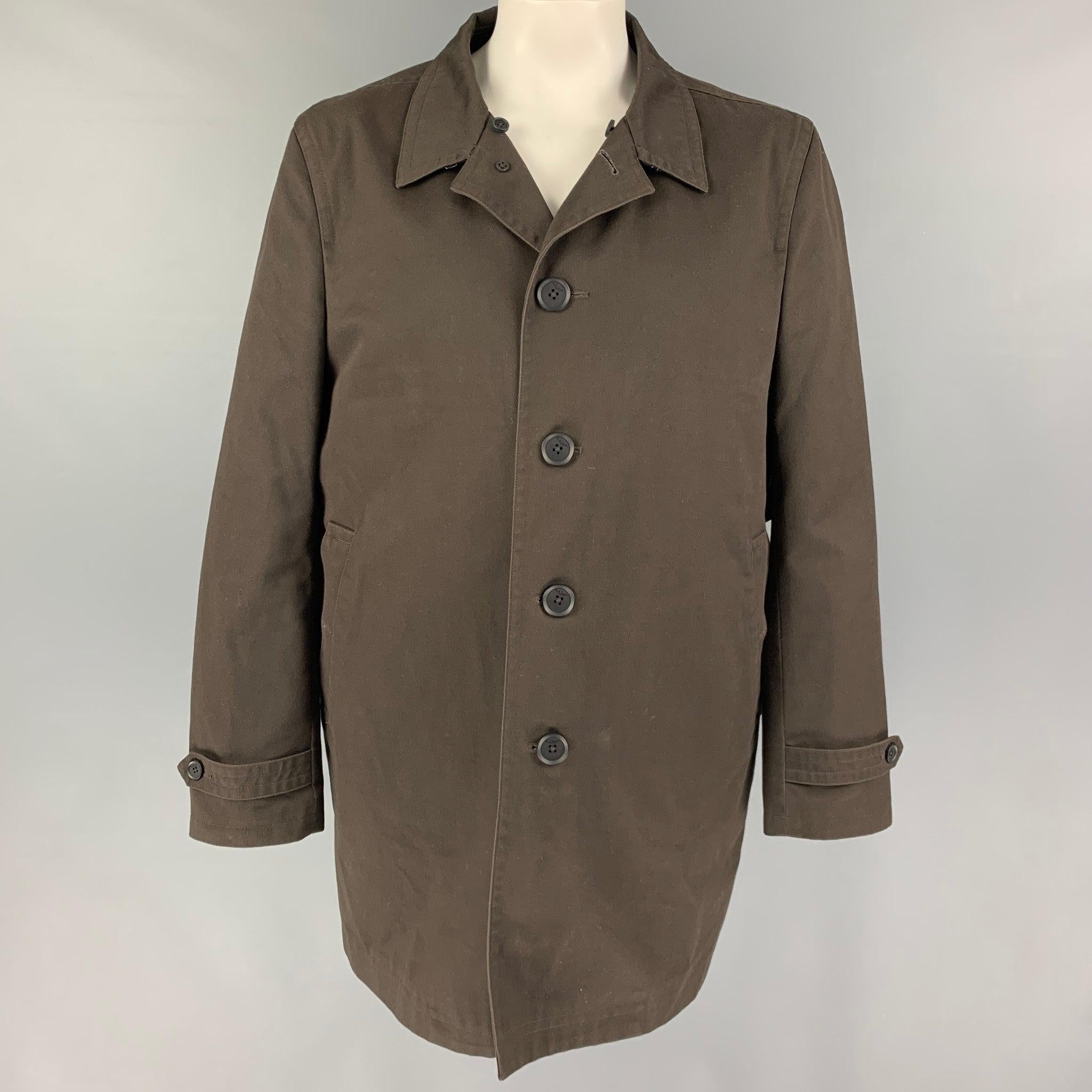 PAUL SMITH coat comes in a brown polyester / cotton with a detachable burgundy liner featuring a detachable shearling collar, back strap, slit pockets, and a buttoned closure. Very Good
Pre-Owned Condition. 

Marked:  XXL 

Measurements: 

