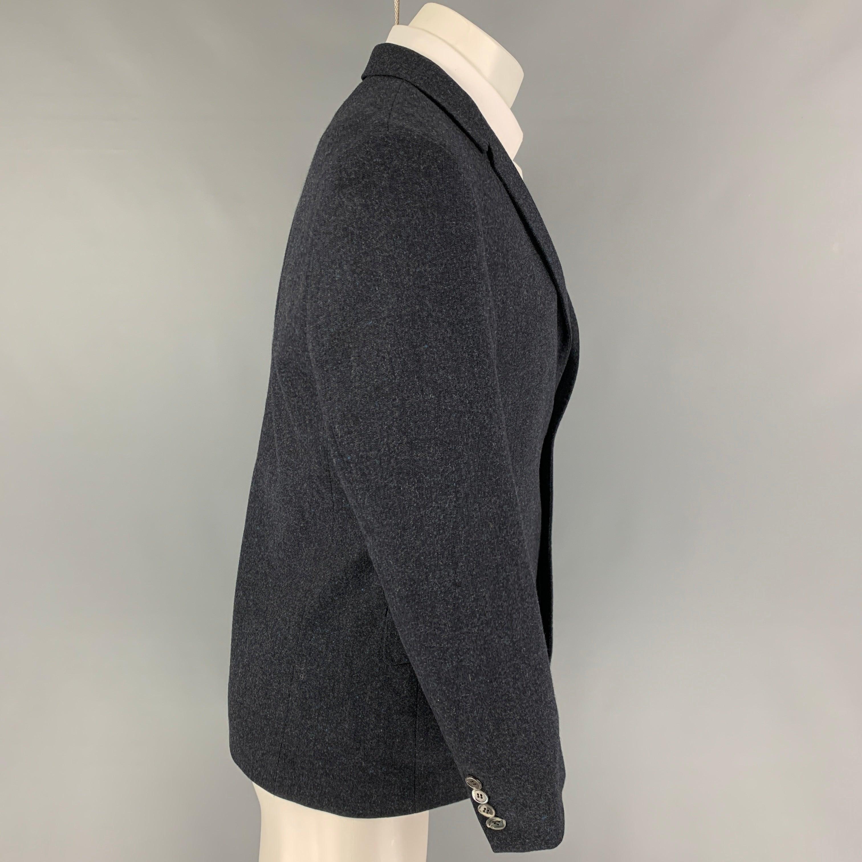 PAUL SMITH 'The Abbey' sport coat comes in a navy heather wool / cashmere with a full liner featuring a notch lapel, flap pockets, and a double button closure. Made in Italy.
Very Good
Pre-Owned Condition. 

Marked:   40/50 

Measurements: 
