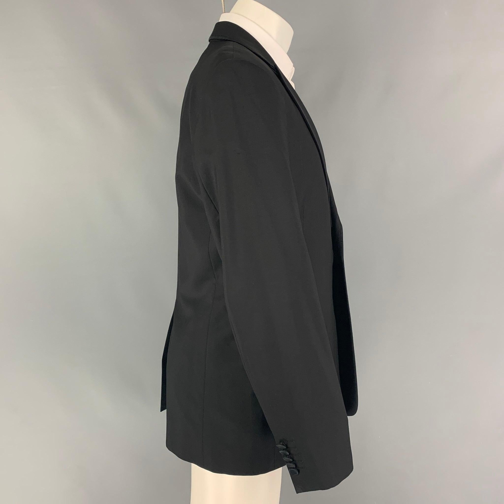 PAUL SMITH 'The Byard' sport coat comes in a black wool with a full liner featuring a peak lapel, flap pockets, single back vent, and a single button closure. Made in Italy.
Very Good
Pre-Owned Condition. Fabric tag removed.  

Marked:   Size tag