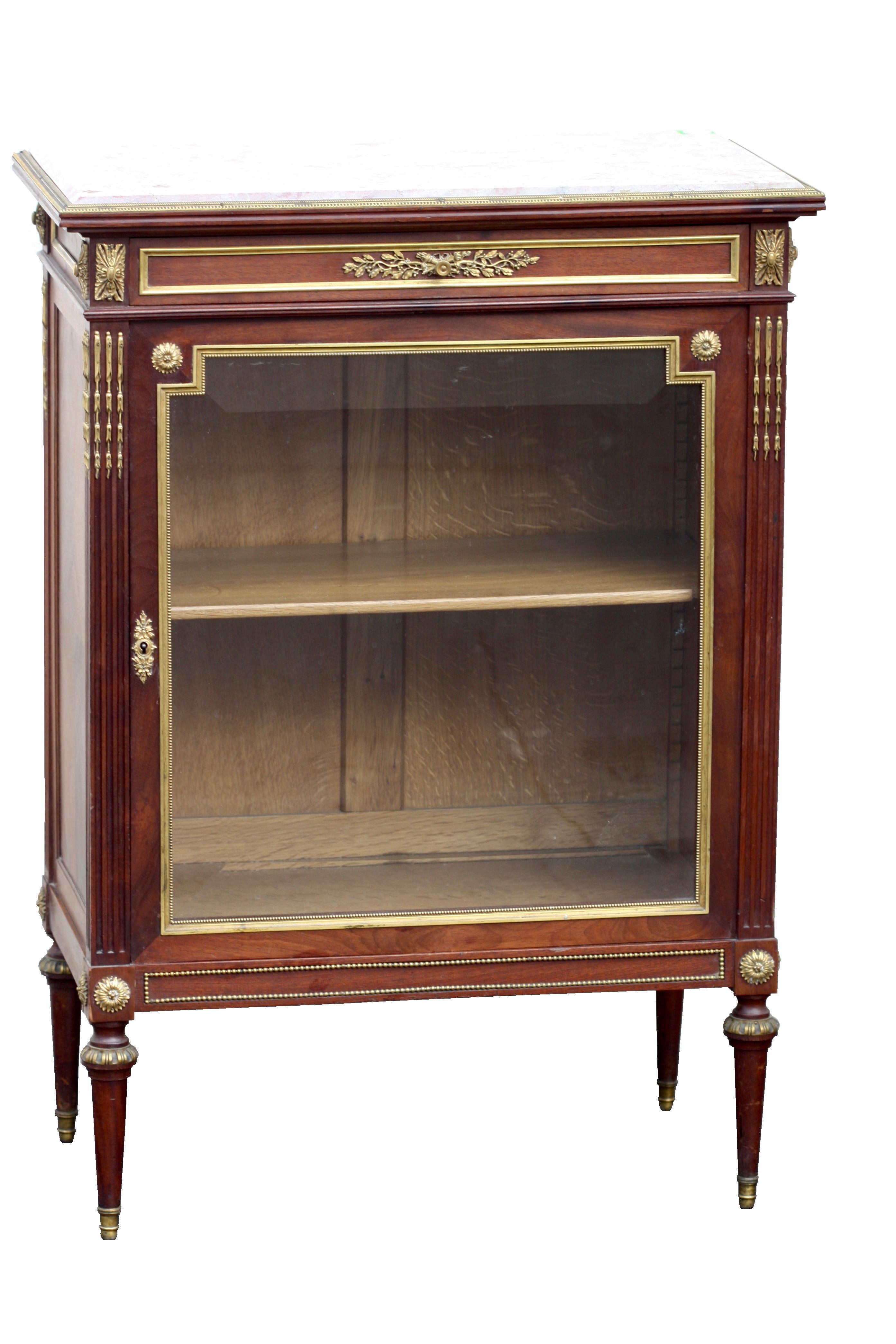 Paul Sormani (1817-circa 1877)
A Louis XVI style ormolu-mounted mahogany vitrine-cabinet
Paul Sormani, Paris, last quarter of the 19th century
The rectangular variegated pink marble top above a long drawer and a cupboard door fitted with a