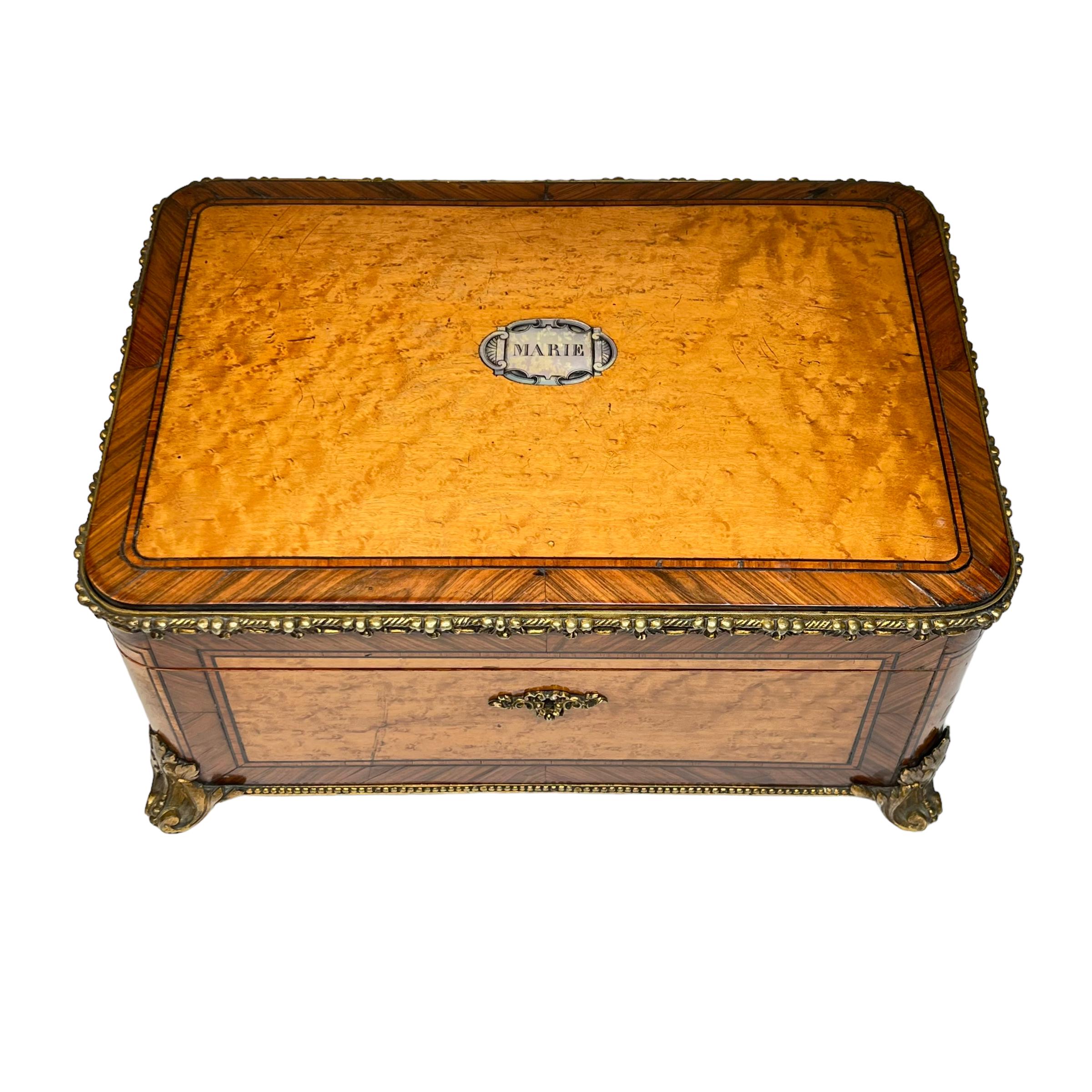 Our fruitwood jewelry chest with bronze mounts and plaque dedicated to Marie comes from the esteemed Parisian cabinet maker, Paul Sormani (1817-1877). Signed and dated on the brass.