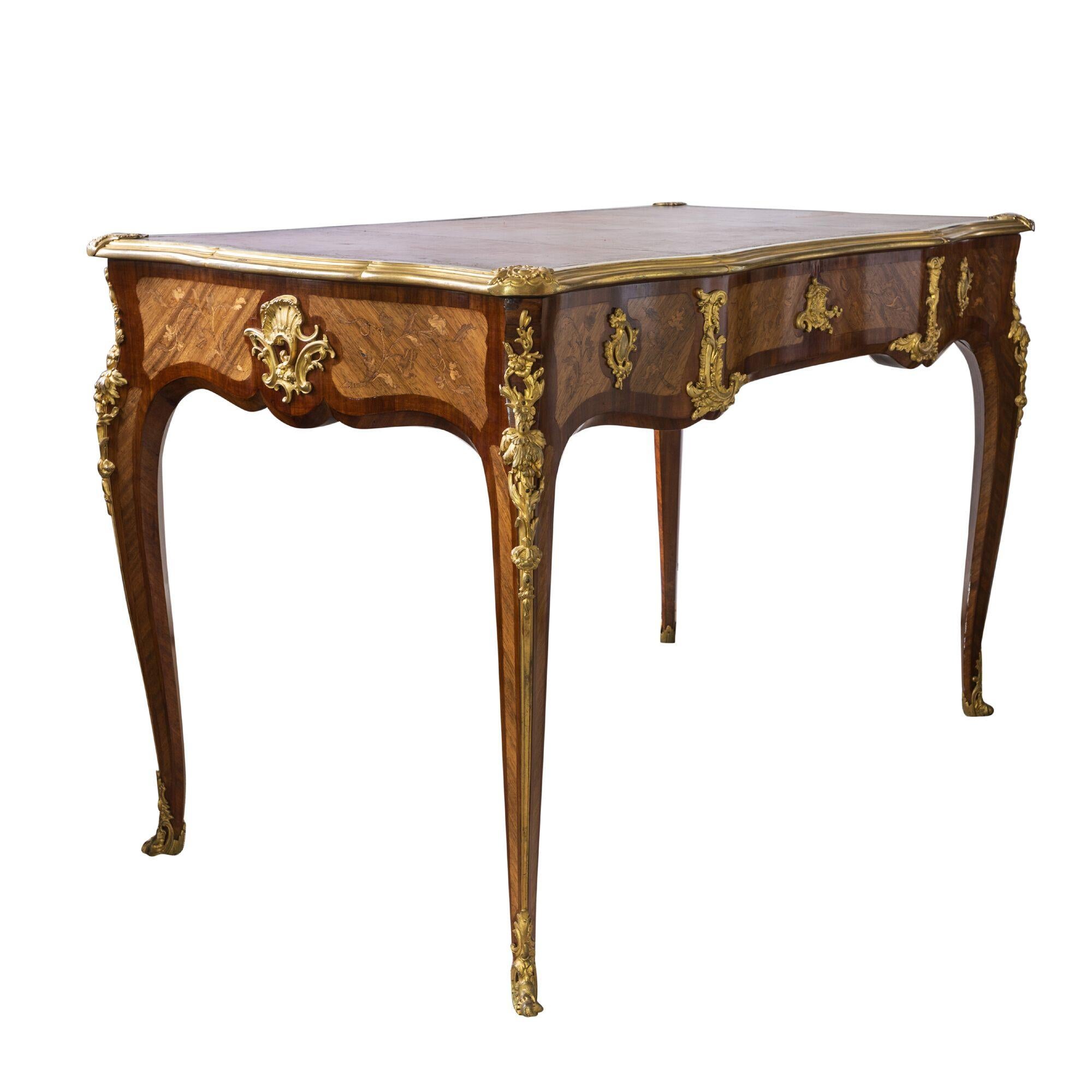 Paul Sormani Louis XIV style bureau plat.
French, circa 1870.
The lockplate to the central drawer signed Paul Sormani/10 r. Charlot. Paris.
The shaped rectangular top inset with red tooled leather and closed by gilt bronze border above three