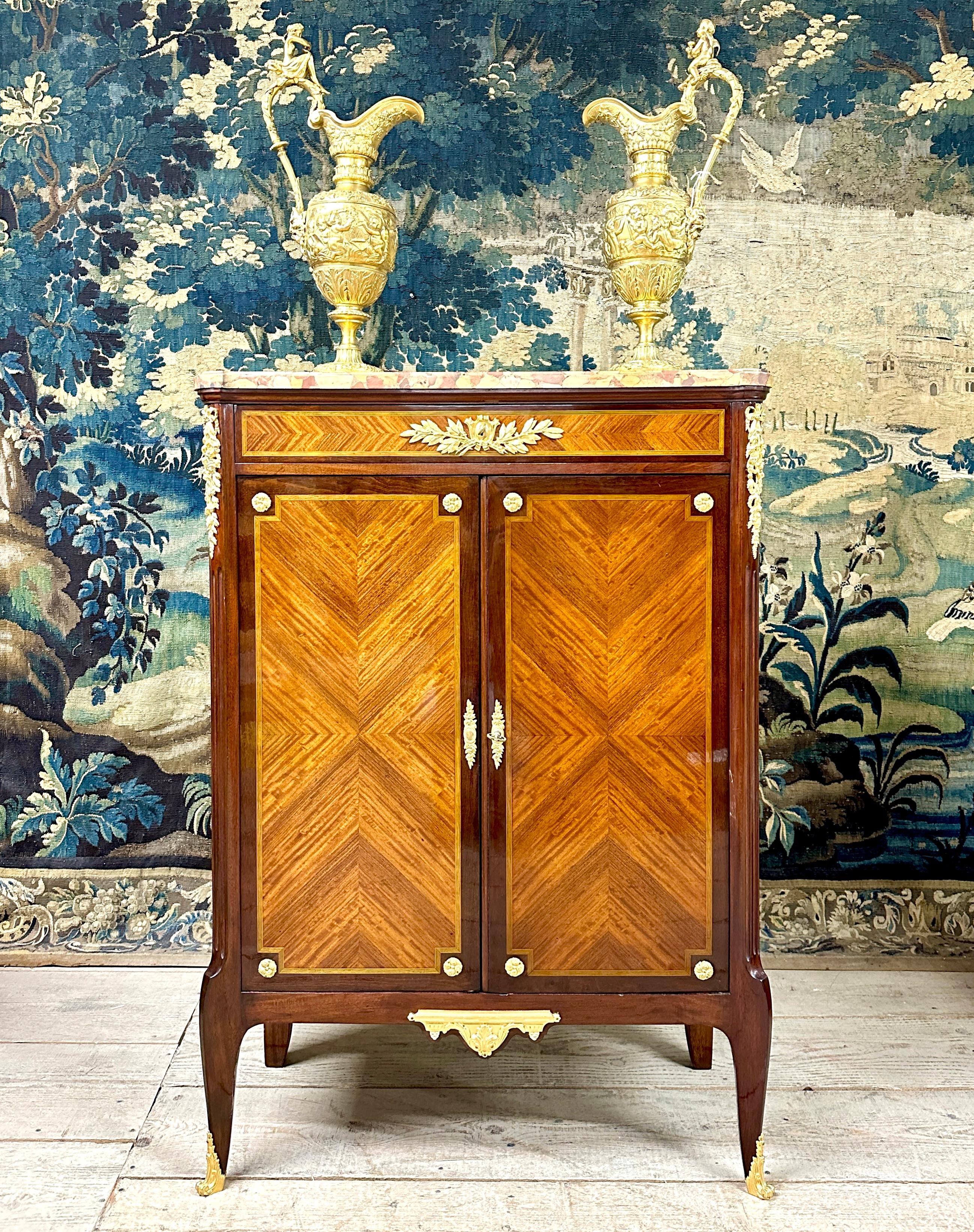 Cabinet in marquetry and gilt bronze by Paul Sormani.  It opens with two doors and a drawer in the belt and has an ornamentation of chiseled and gilded bronzes. Aleppo breccia marble top. Signature under each bronze 