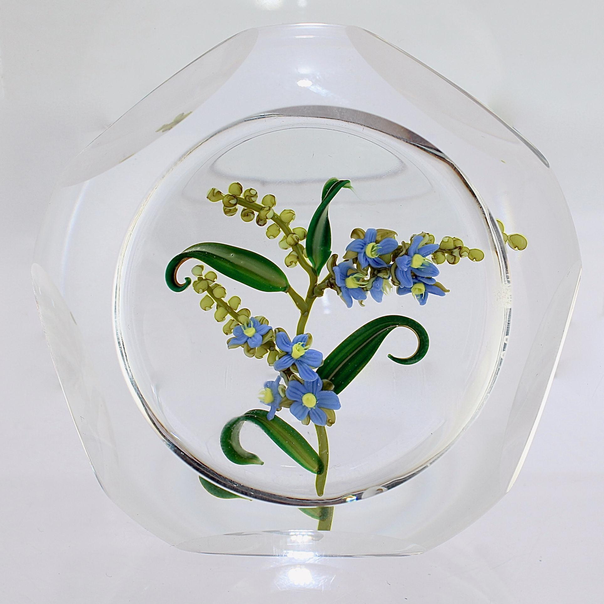 A fine Paul Stankard glass faceted paperweight.

With lampwork forget-me-not flowers in blues and yellows with green stems and leaves.

Bearing a signature cane and etched edition number to the side.

Simply a wonderful paperweight from one of
