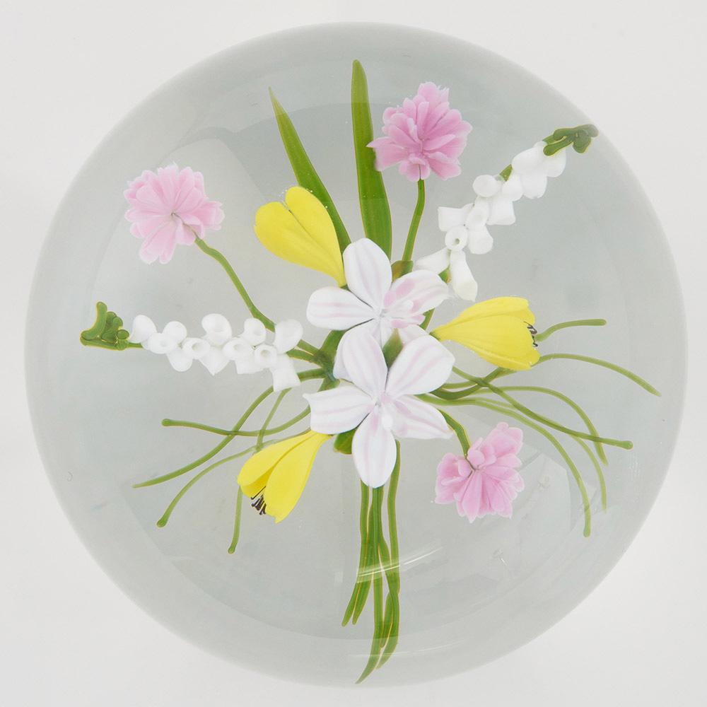 Heading : A Paul Stankard paperweight
Date : 1980
Origin : USA
Features : An open bouquet of spring flowers with foxgloves and crocuses with asociated foliage
Marks : Incised on the flank Paul J Stankard and D931 80. Black S on white signature