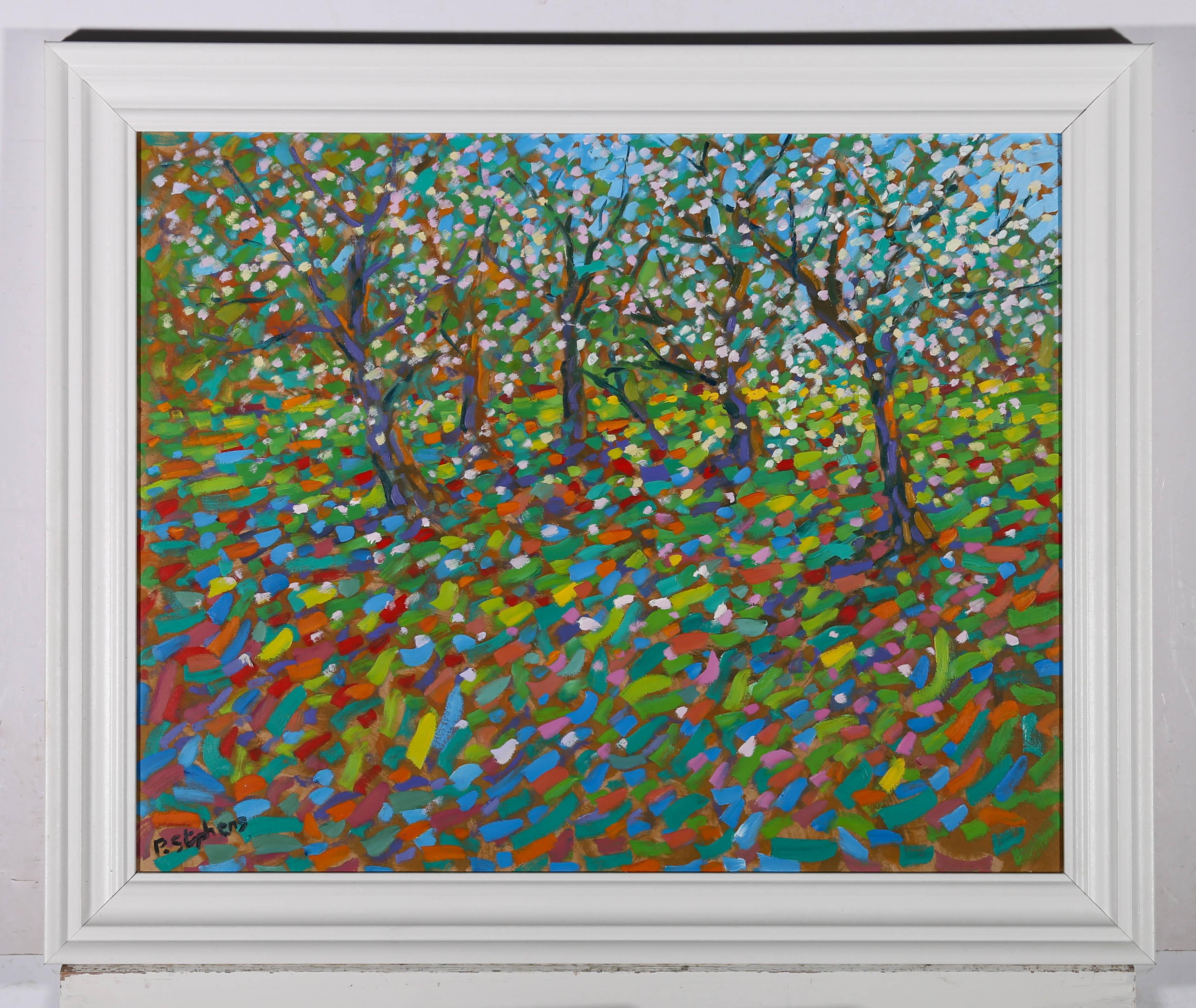 A vibrant impressionistic oil scene of apple blossoms in the orchard. The artist has used flecks of paint to create the image which is typical of his style. He has signed to the lower left and the work has been presented in a sleek white frame. On