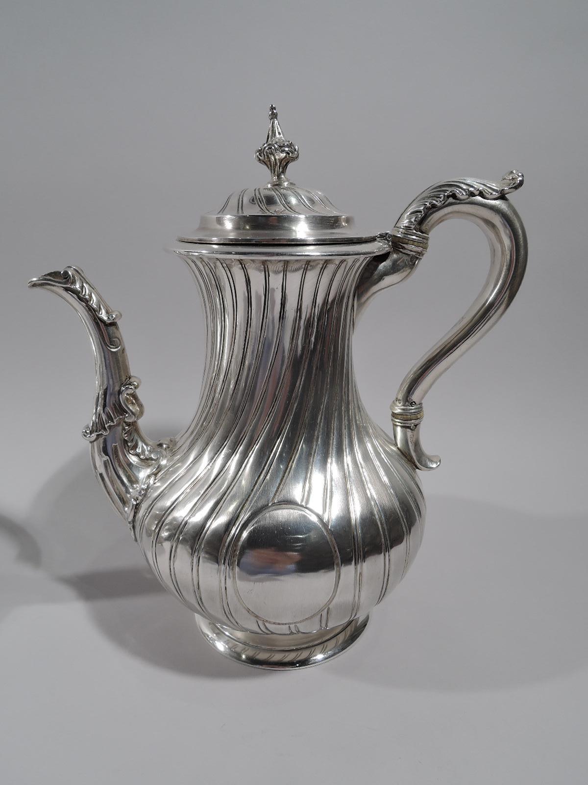William IV sterling silver coffee and tea set. Made by Paul Storr in London in 1835. This set comprises coffeepot, teapot, creamer, and sugar.

Late Regency Classicism with dynamic twisted fluting. Coffeepot and creamer baluster, and teapot and