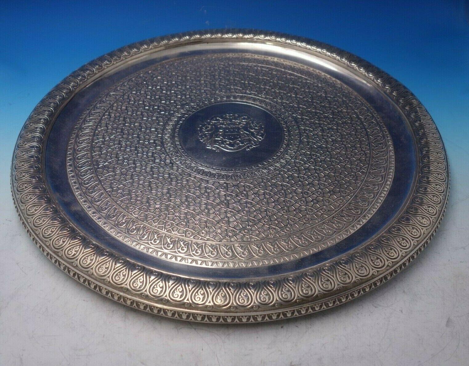 Paul Storr

Extraordinary Paul Storr English Victorian sterling silver round tray engraved #122. This tray was made in London circa 1837. This piece features a detailed chased coat of arms in the center with a pair of whippet dogs, and has an