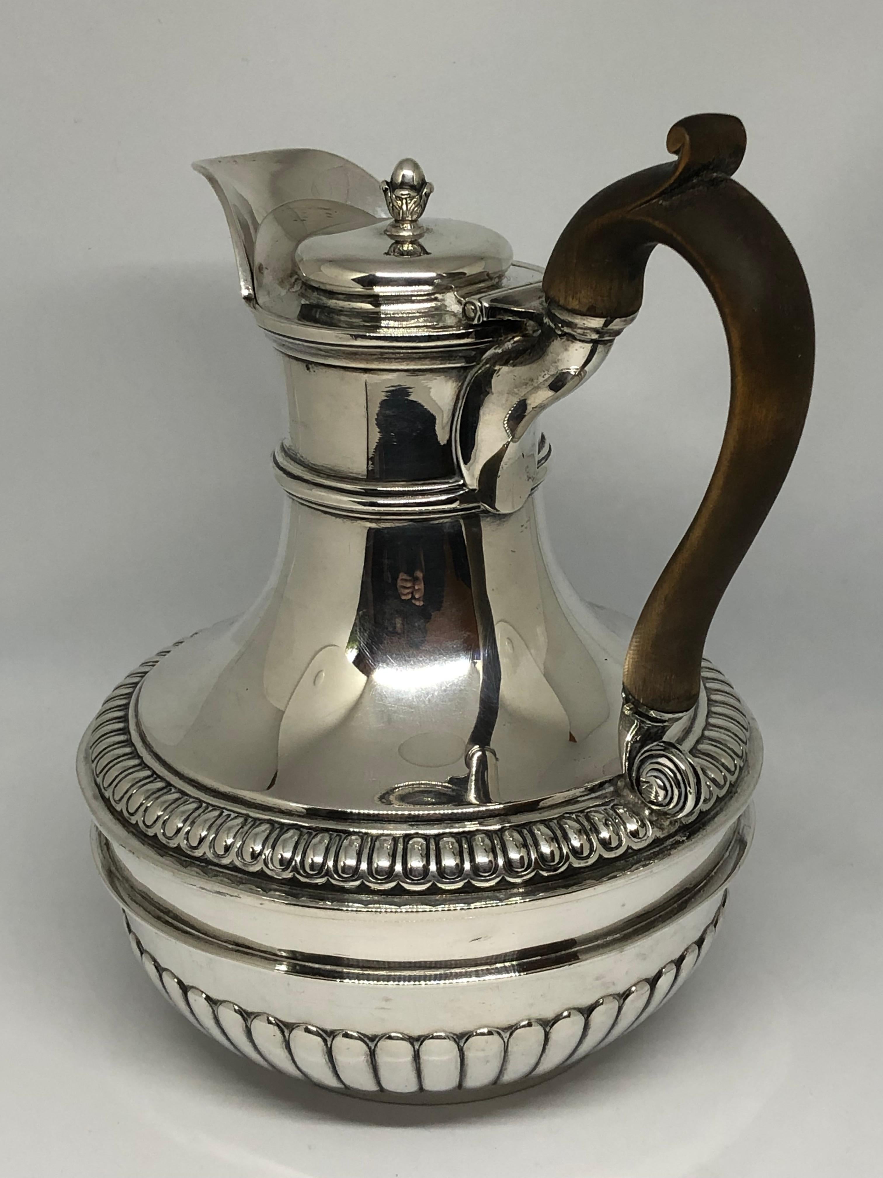 By the most famous and sought-after goldsmith and silversmith of the nineteenth century - Paul Storr.

A George III Regency silver jug on stand. Decorated with gadrooning, the jug with fluting to the lower half. Atop a stand supported by three