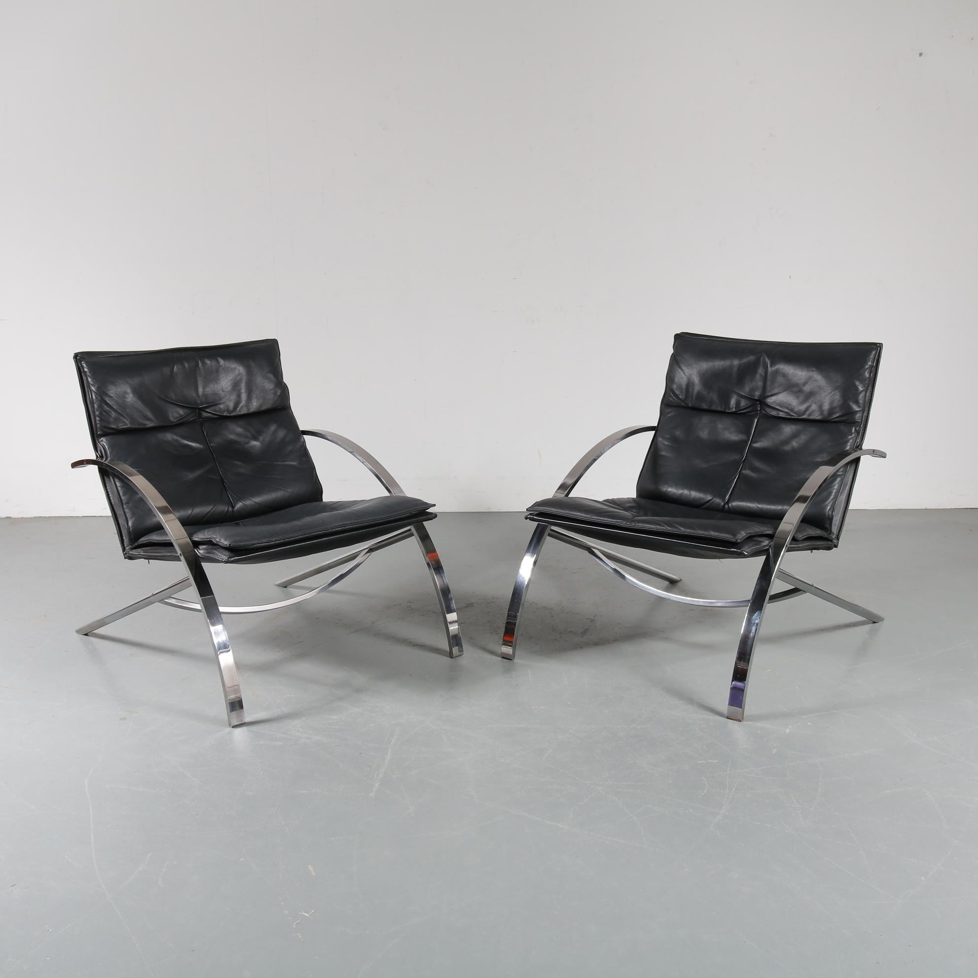 A unique pair of “Arco” lounge chairs designed by Paul Tuttle, manufactured by Strässle in Switzerland in 1976.

Made of beautiful chrome-plated metal in bent shapes, with a smooth leg to armrest transition. The seats and backs are upholstered in