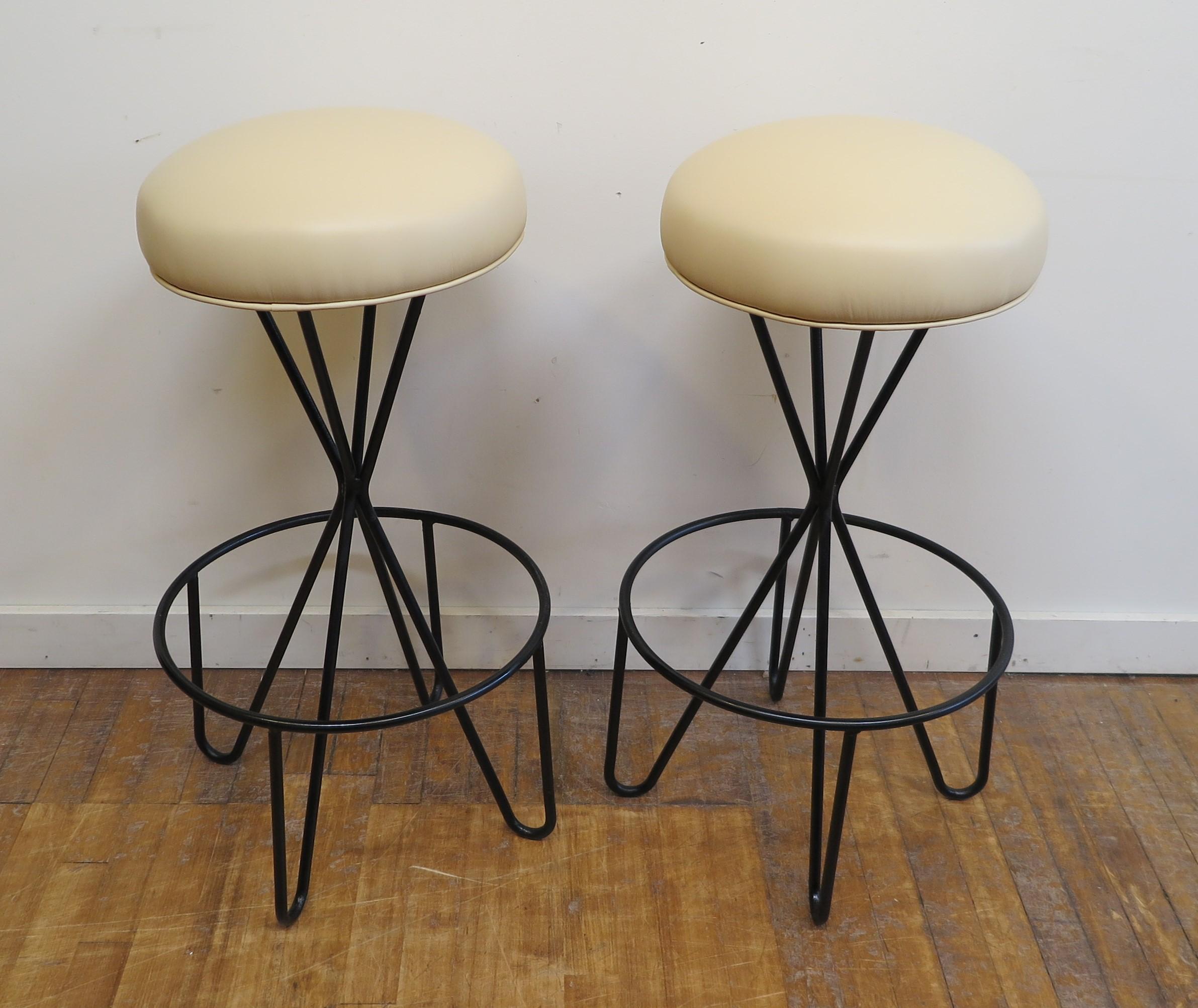Mid Century Swivel Stools by Paul Tuttle.  Hairpin leg Swivel Stools Iron - Steel frames with spring bound seats. Seat diameter 14 inches. In very good condition. Maintaining the original spring seat with new cushioning, newly covered in ivory high