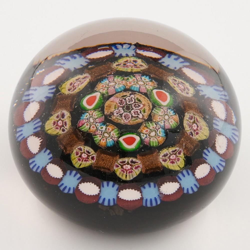 Heading : A Paul Ysart Magnum Concentric Millefiori Paperweight c1950
Date : c1950
Origin : Scotland
Features : Three concentric rings of alternating millefiori canes inc complex canes and aventurine links all around a central complex cane
Marks :