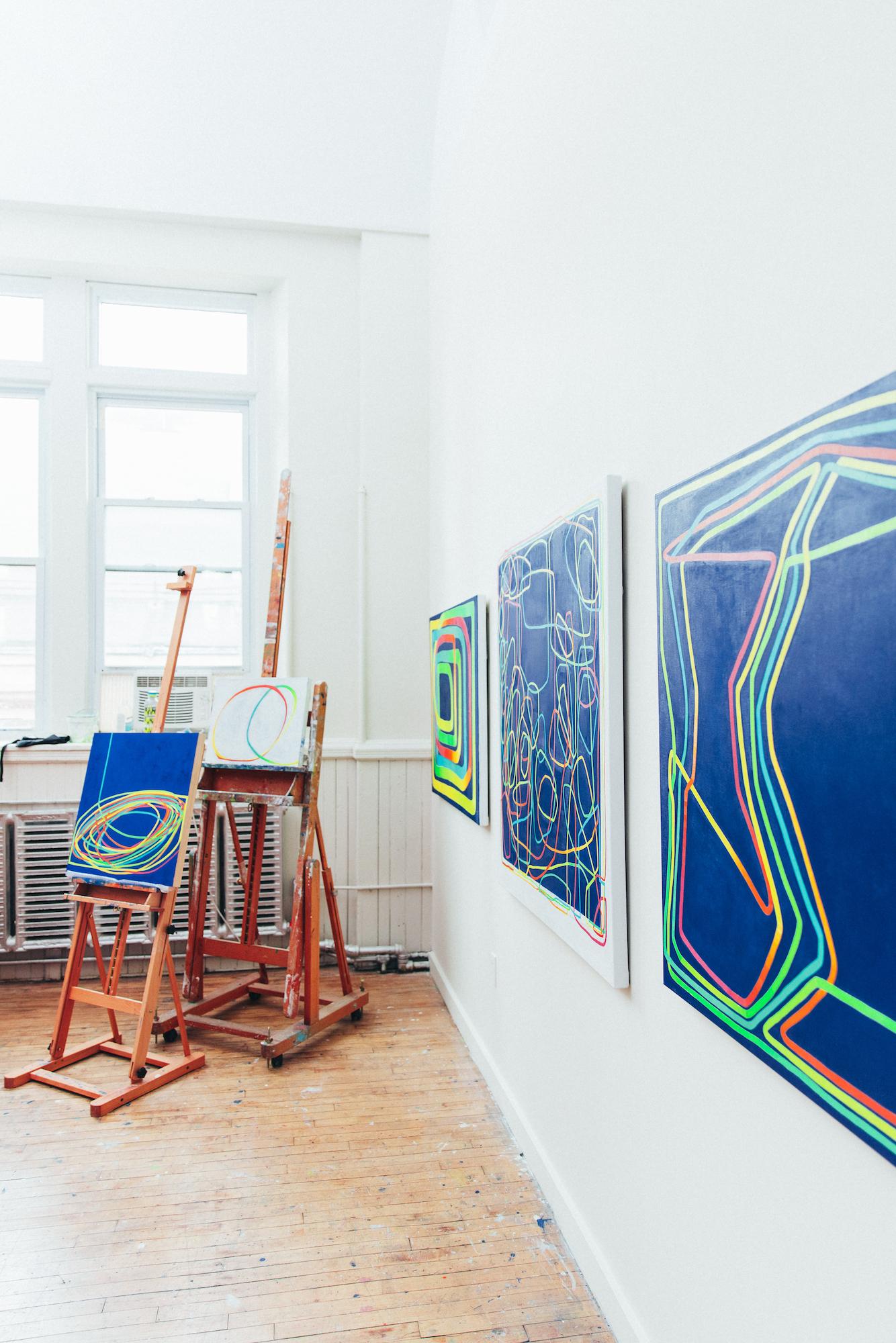Paula Cahill's linear abstract compositions are often comprised of a single, luminous line that meanders, changes color, and seamlessly connects back to itself. This piece combines Cahill''s signature color-changing line on a deep blue background