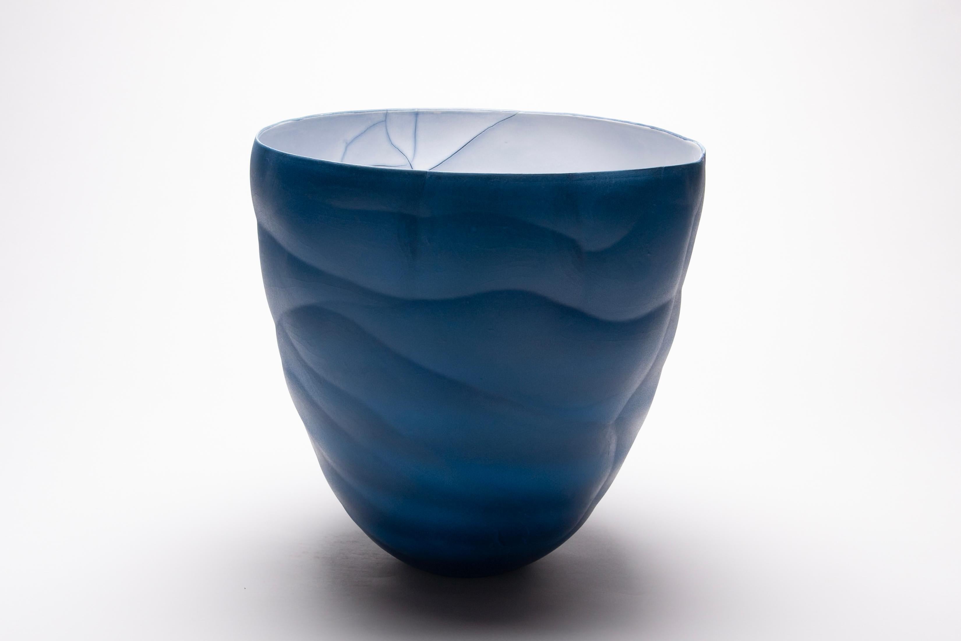 This contemporary porcelain blue vessel is by Paula Murray.

Paula Murray’s elegant sculptural artwork is inspired by forms and patterns found in nature. Her sublime sculptural ceramics are intended to reflect the deeply spiritual connection between
