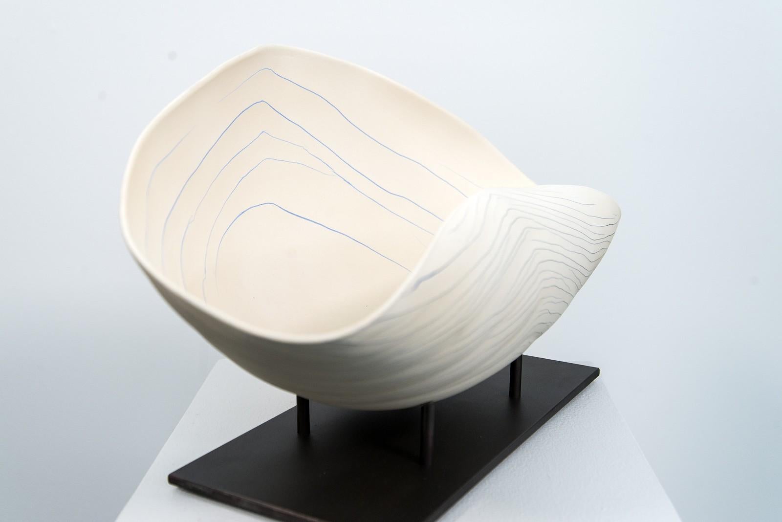 In her Quebec studio, ceramic artist Paula Murray uses her own recipe for porcelain clay that she hand-shapes into intricate pieces and permits the natural drying tensions between her mediums to create unusual abstract shapes. Inspired by forms and