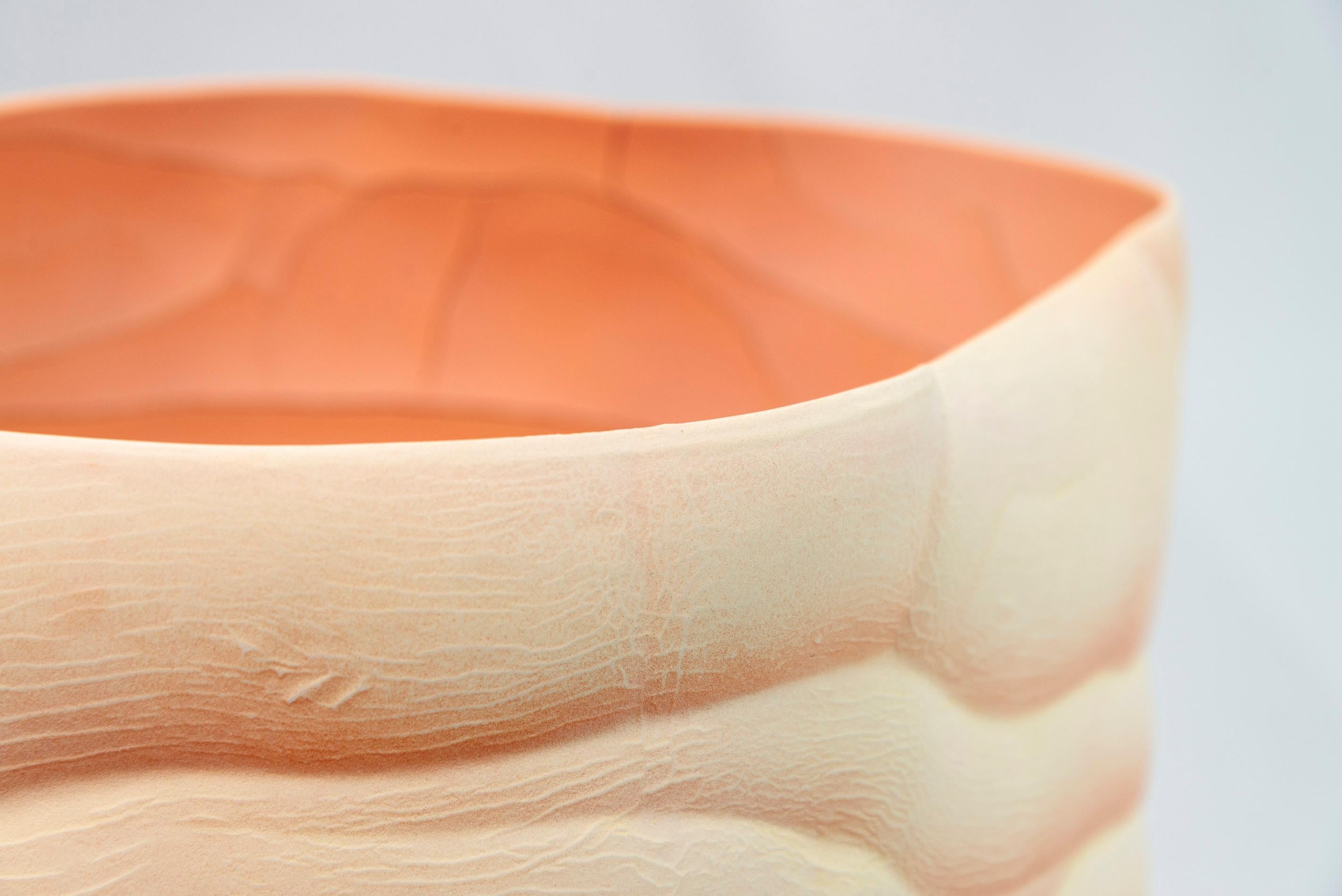 In her lakeside studio surrounded by nature, Paula Murray creates uniquely beautiful porcelain pieces. This vessel has a tall undulating form accentuated by waves of lines that run both outside and inside. The colour is extraordinary—a rich saffron