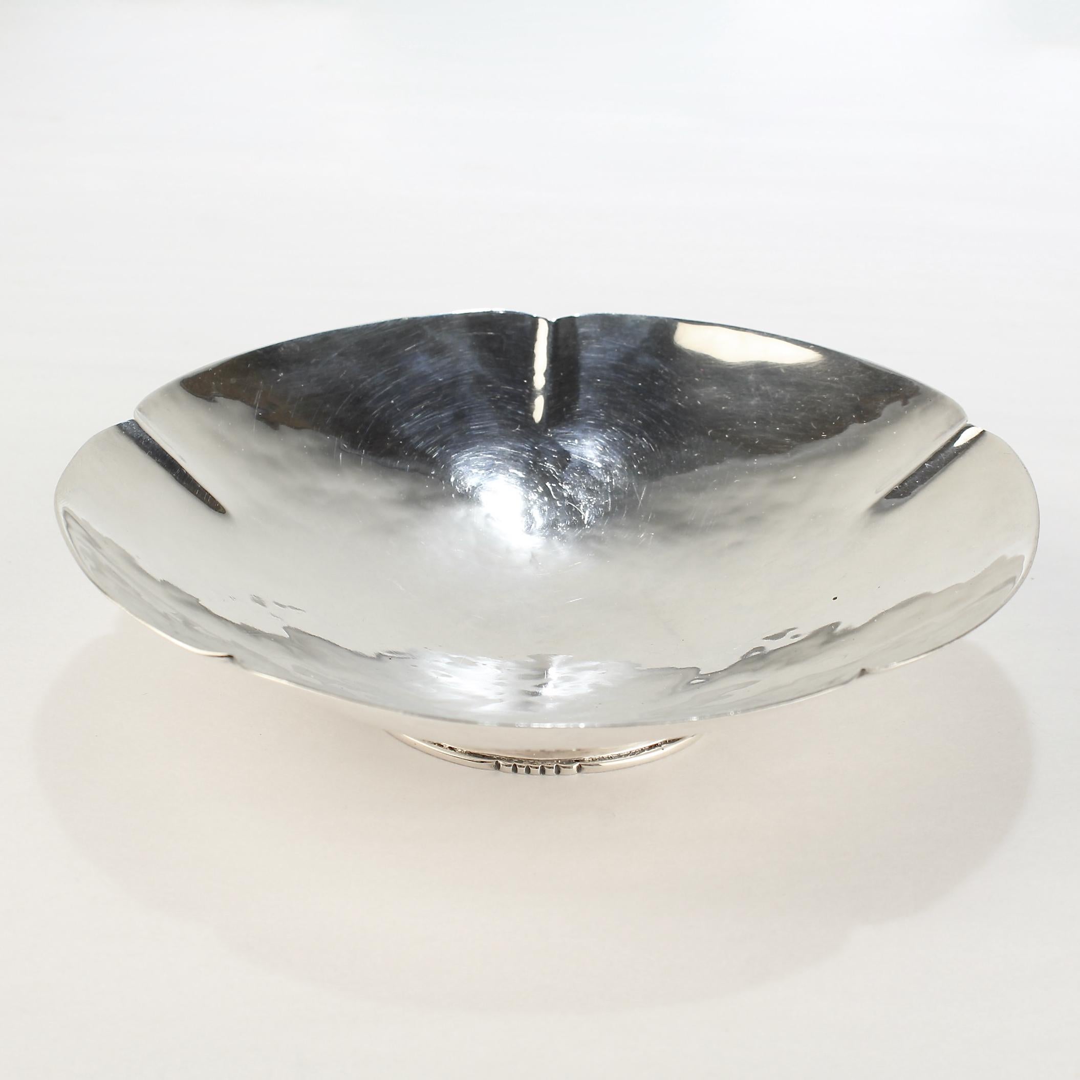 A fine hand-hammered Arts & Crafts footed dish or bowl. 

With a lobed-hand-hammered bowl mounted on a shaped foot. 

In sterling silver. 

Made by the American female silversmith Paula Wyman.

Simply a wonderful piece of American Arts & Crafts