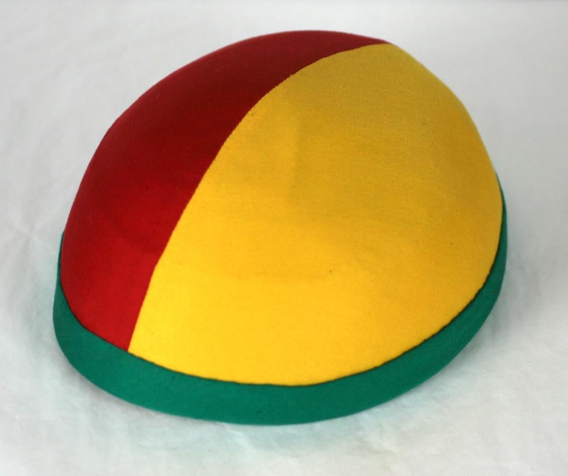 Paulette collaboration for Claude Montana, Tri color couture cap of Pan-African colours, red, golden yellow, and green silk. 
Entirely hand made and sewn on a straw base. From the Spring/Summer 1979 show.
Excellent Condition.  Made In France.