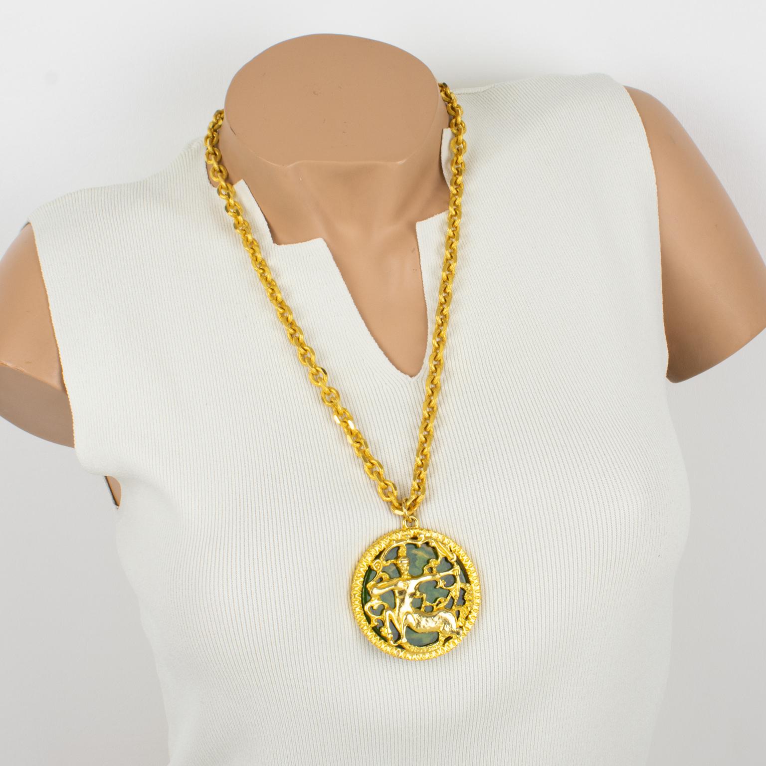 This spectacular Pauline Rader necklace features a massive dimensional pendant design with shiny gilded metal framing embellished with a green spinach marble Bakelite background. The pendant has a lovely intricate centaur carved and see-thru design.