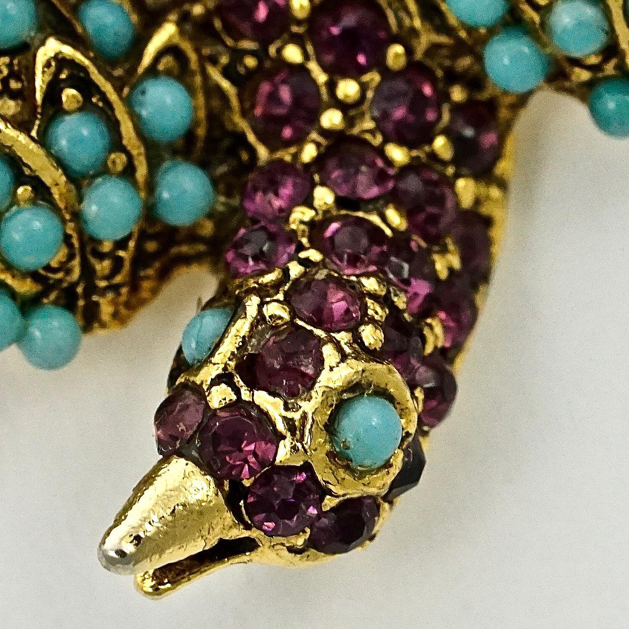 Pauline Rader beautiful gold plated bird brooch, set with amethyst rhinestone and turquoise glass stones. Measuring length 4.7 cm / 1.85 inches by width 2.9 cm / 1.14 inches. 

This very lovely vintage brooch by Pauline Rader is circa 1960s. A rare