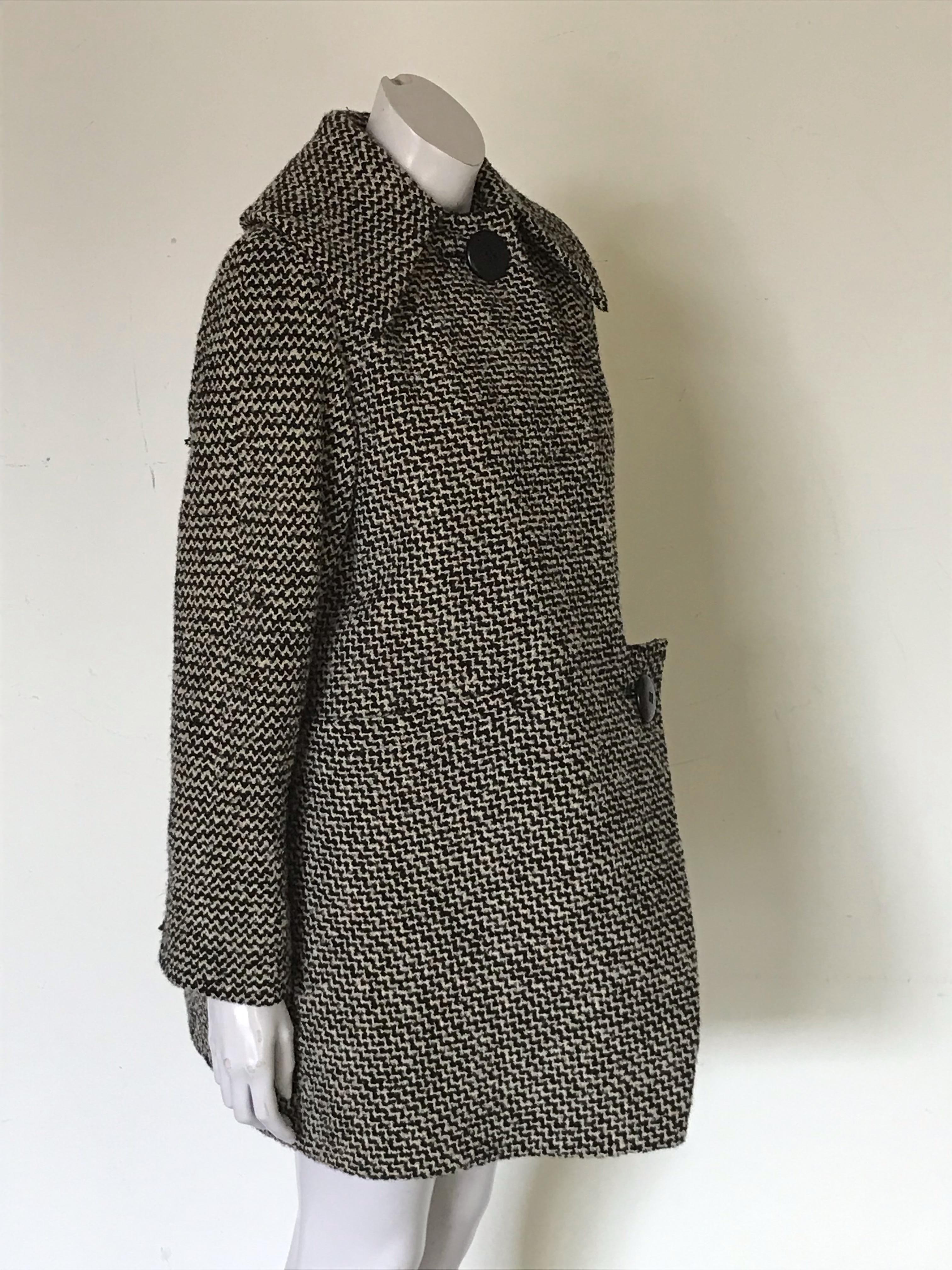 This is a two-piece weed coat and dress set from Pauline Trigere, this appears to be 1960s era.

Coat features asymmetric front, two button closure, two horizontal front pockets .

Mid-calf length dress is fitted through waist, side zipper closure,