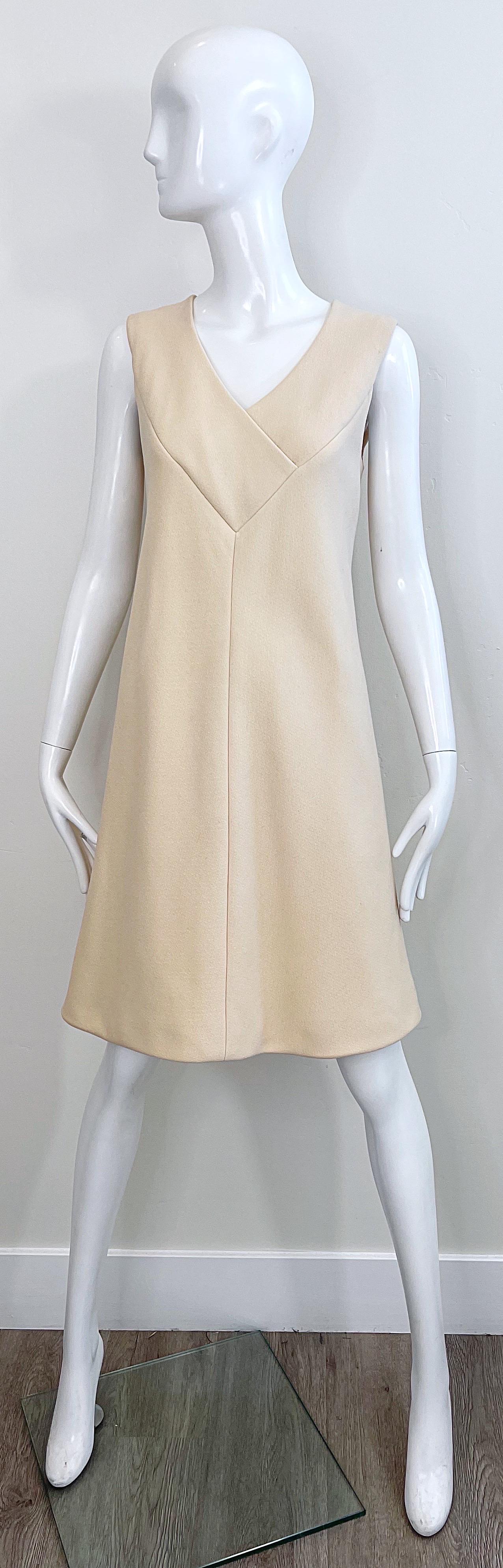 Chic 1960s PAULINE TIRGERE off-white / ivory sleeveless A-line wool dress ! Features a v-neck with a tailored bodice and slightly flared skirt. Hidden metal zipper up the back with hook-and-eye closure. Fully lined in silk. 
Very well made with lots