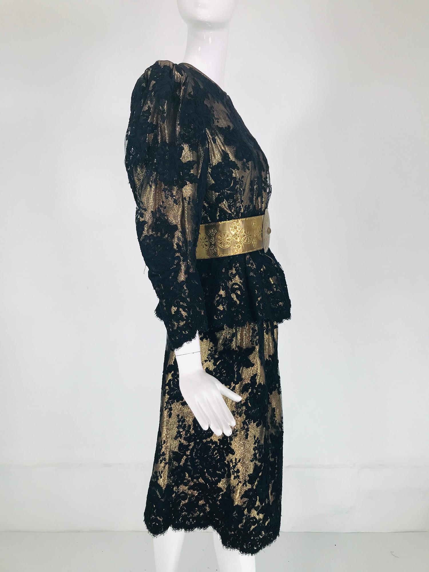 Pauline Trigere black Guipure lace over gold lame', 2pc skirt set from the 1980s. The top has a jewel neckline and is seamed at the waist, flaring at the hem. The sleeves have padded shoulders and full and padded at the top tapering to the wrist.