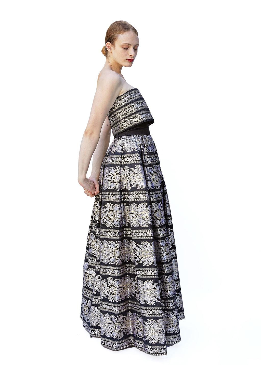 This Pauline Trigere Brocade gown is the epitome of royalty and elegance. Made with intricate metallic brocade fabric, it is a show stopping piece perfect for formal black tie events, red carpets, and more. The strapless design comes with a matching