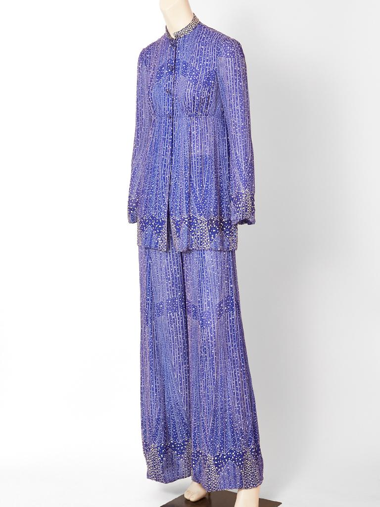 Pauline Trigère, layered chiffon, tunic and pant ensemble in a celestial blue tone.  Ensemble has a delicate geometric pattern. The tunic has an empire waist, a rhinestone embellished, mandarin collar, with a sprinkling of rhinestones towards the