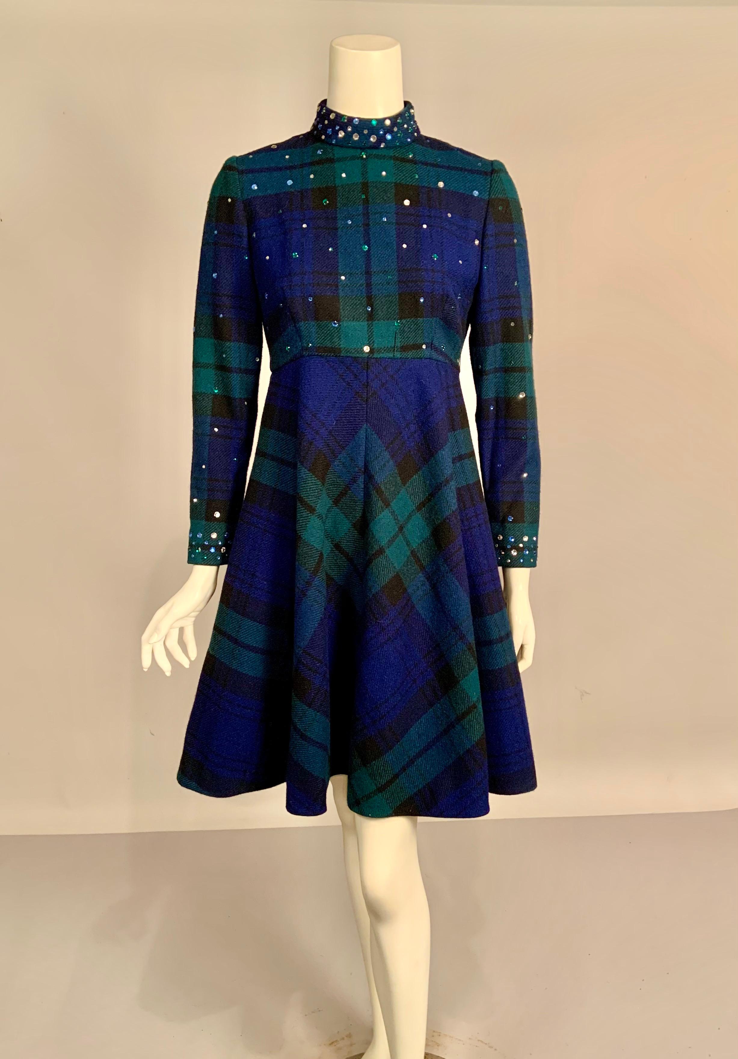 This dress designed by Pauline Trigere is another variation on the rhinestone studded dresses and coats that she is known for creating.  It is a soft wool in a classic Black Watch Tartan plaid.  The top of the dress is studded with prong set