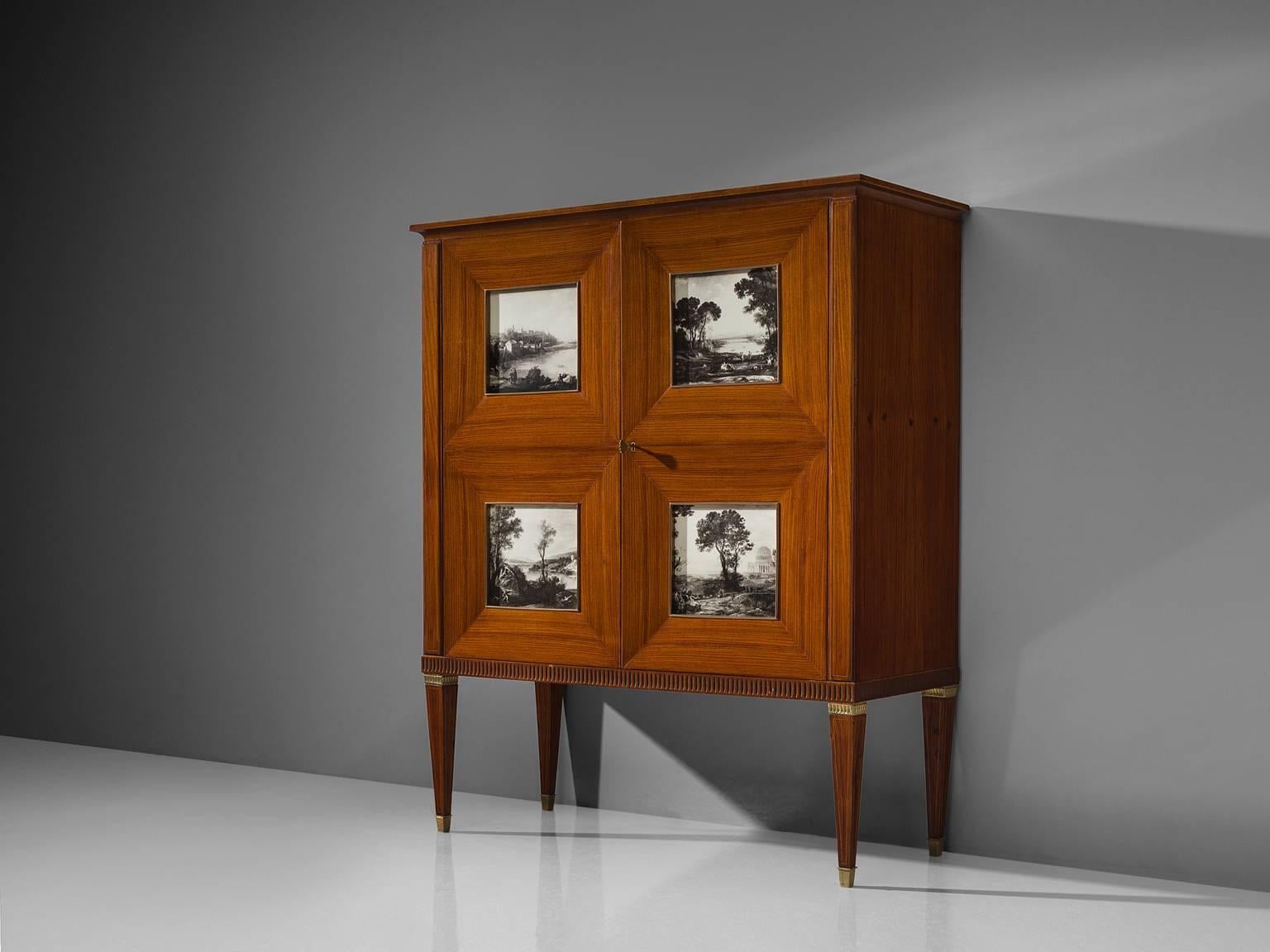 Paolo Buffa, dry bar, cabinet, rosewood, brass and glass, Italy, 1940s. 

This large liquor cabinet with editioned etchings and conical legs is designed by Paulo Buffa. The veneered bar features inlayed patterns in the wood and four windows behind