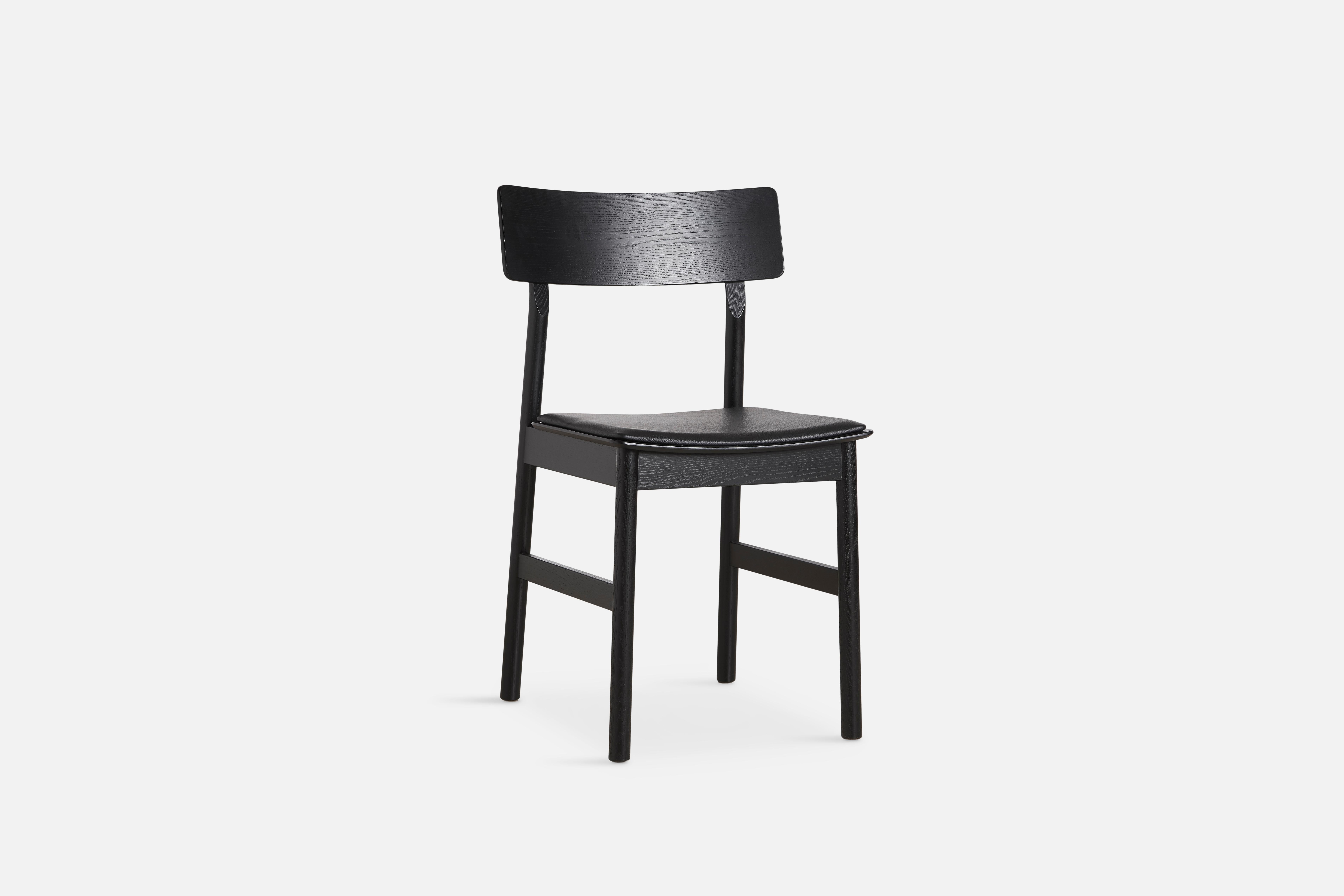 Pause black dining chair 2.0 with leather seat by Kasper Nyman
Materials: ash, plywood, leather, upholstery 
Dimensions: D 47 x W 48 x H 80 cm
Also available in different colors and finishes. 

The founders, Mia and Torben Koed, decided to put
