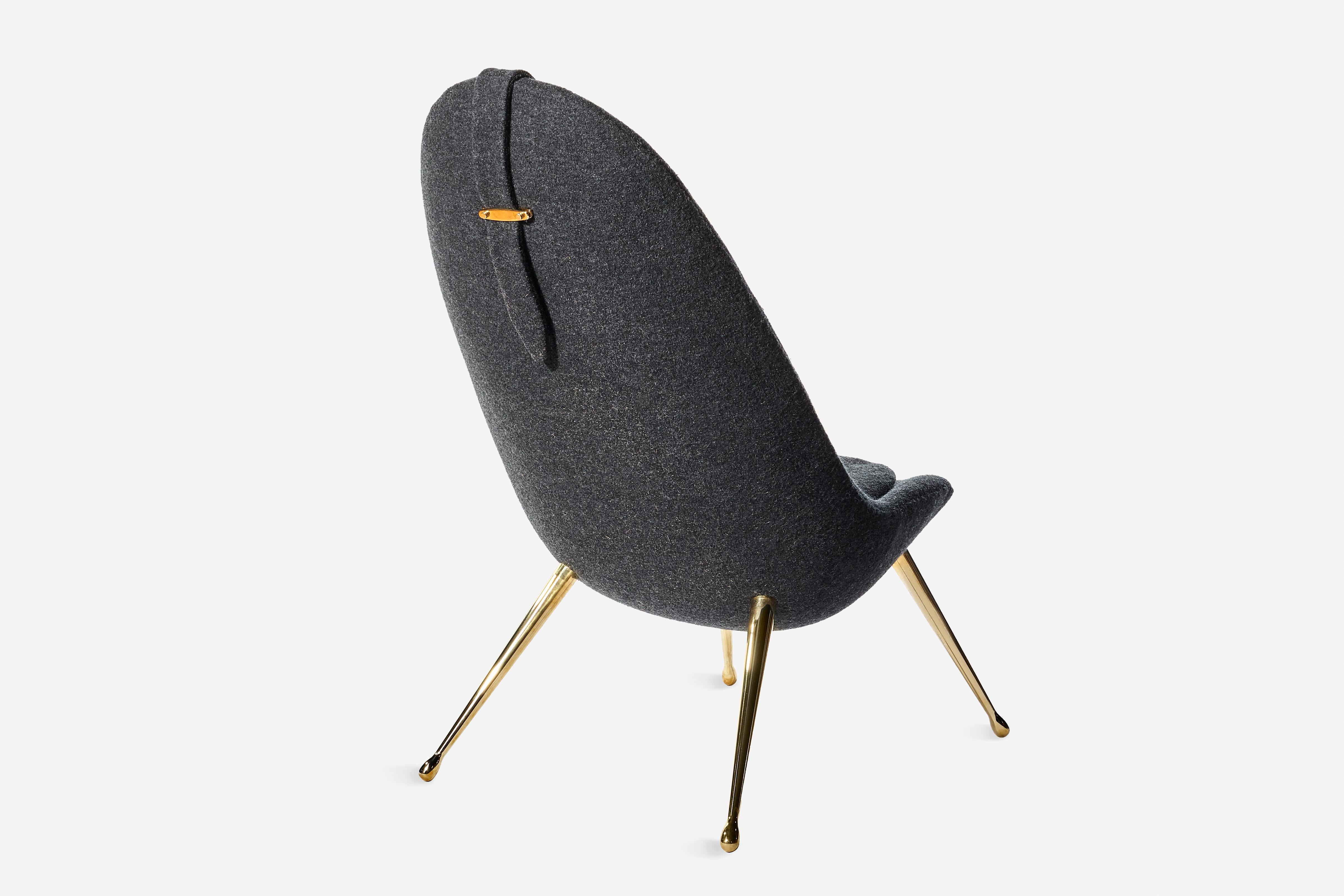 The Pause Chaise Lounge is upholstered with graded-in fabric or COM and features solid brass legs. With a fiberglass shell designed to embrace the body, this sculptural lounge chair is intended as the ultimate seat to unplug and unwind in.