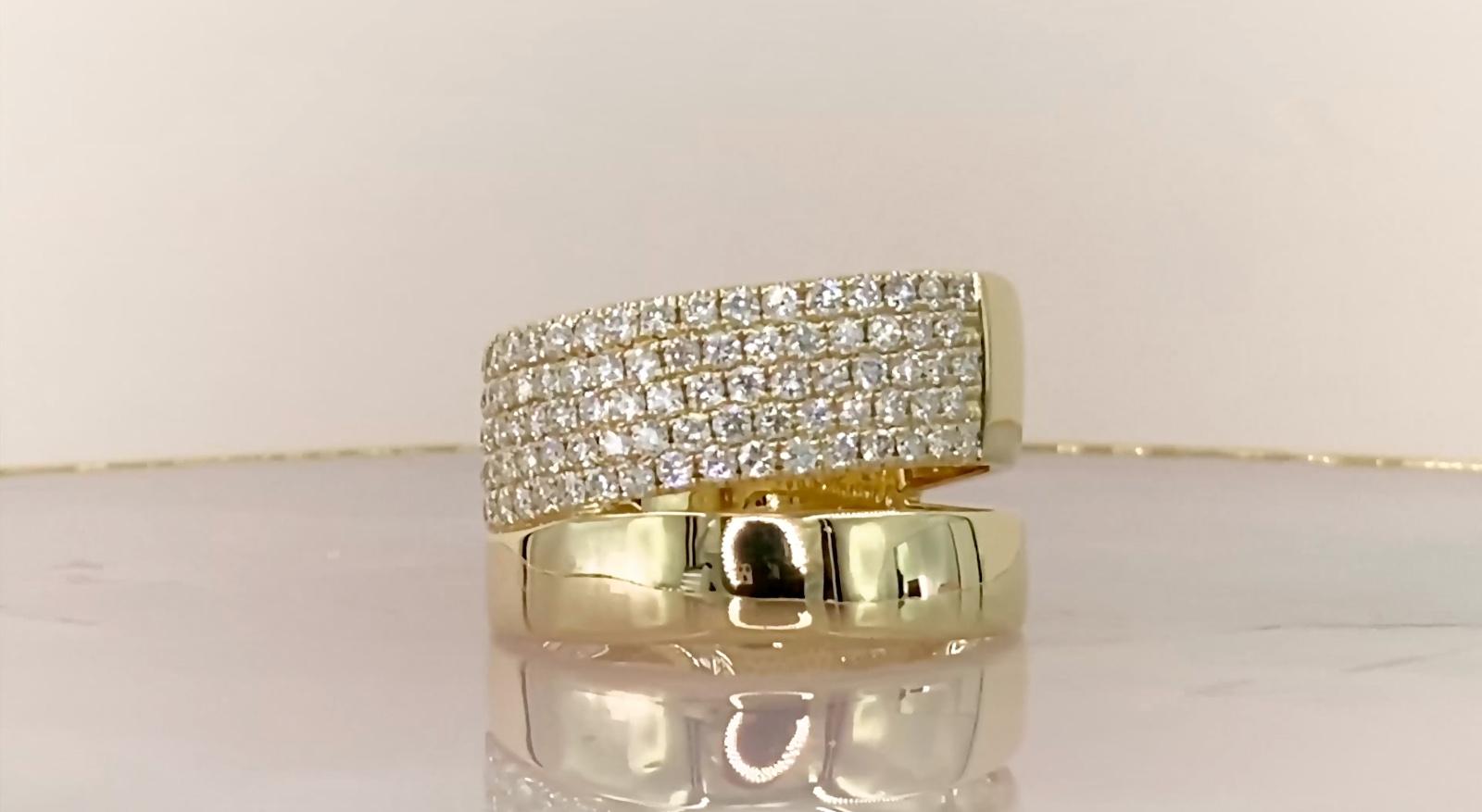 Round cut diamonds (1.03 total carat weight) pave split band ring in 14k yellow gold. The ring is designed and handmade locally in Los Angeles by Sage Designs L.A. using earth-mined and conflict free diamonds. The ring weighs 6.5 grams and all