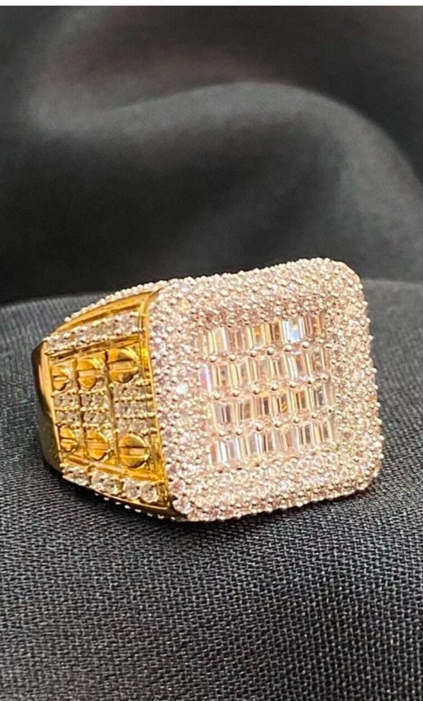 ELEVA TU ESTILO CON ESTE IMPRESIONANTE ANILLO DE COMPROMISO PARA HOMBRE .
ELABORADO CON ORO AMARILLO DE 14K, ESTE ANILLO PRESENTA UNA HERMOSA COMBINACIÓN DE DIAMANTES REDONDOS Y BAGUETTE EN ENGASTE PAVÉ. EL PESO TOTAL DE 3,62 QUILATES SEGURO QUE