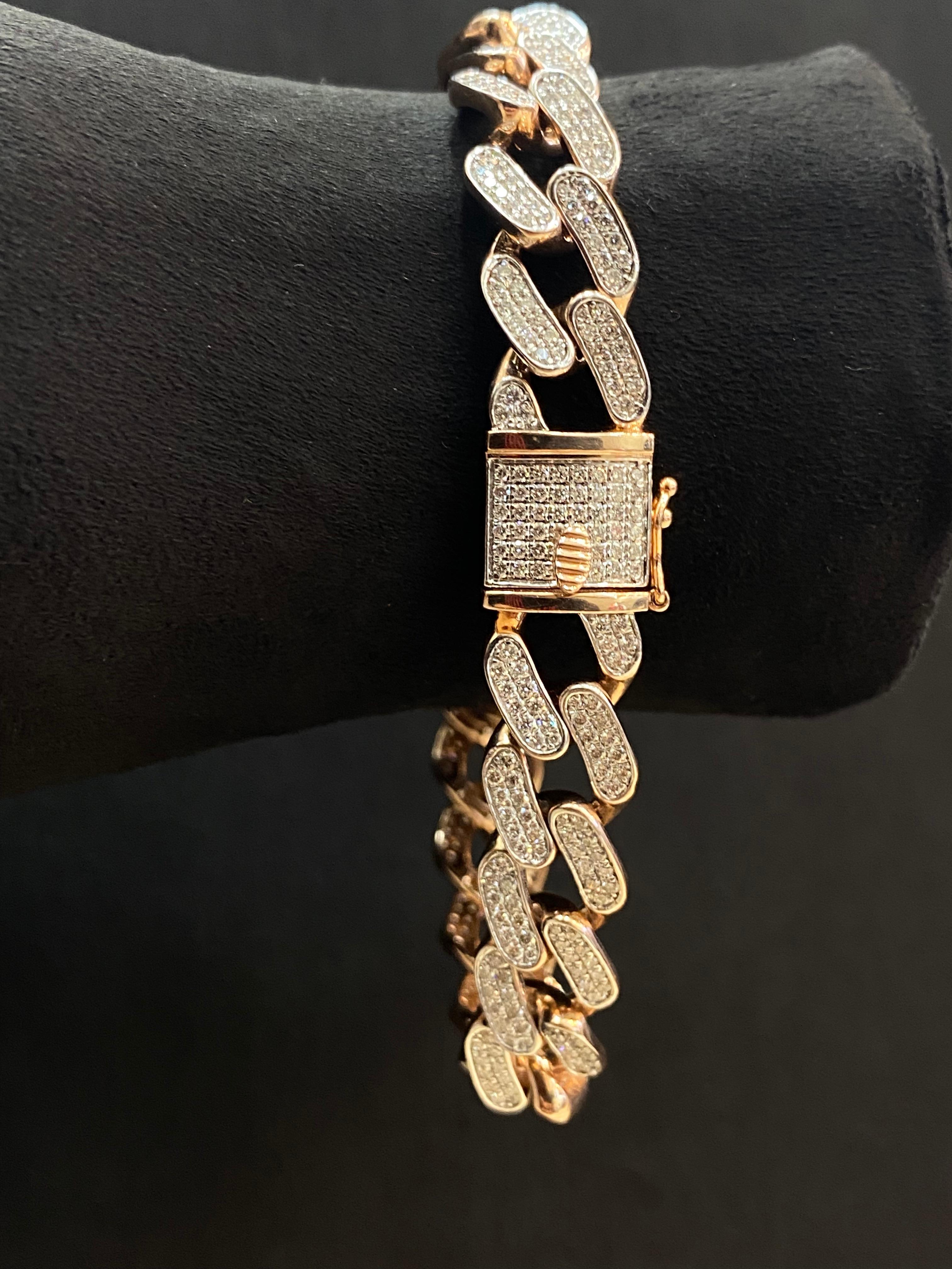 This men's tennis bracelet is crafted from stamped 14K rose gold and showcases an impressive arrangement of F/VS1 round brilliant cut diamonds, totaling 4.66 carats. These exquisite diamonds are elegantly nestled within the iconic cuban link design,