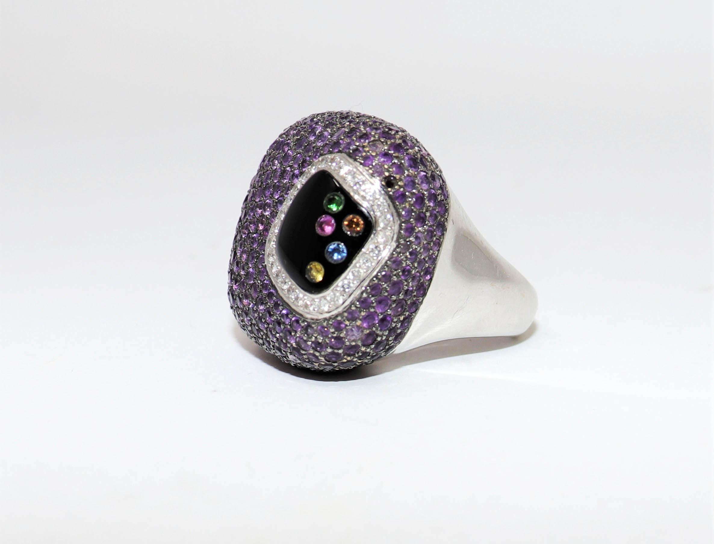 Ring size: 7

If you are looking for a bold, colorful, and sizable statement piece, look no further than this! Absolutely incredible cocktail ring filled from edge to edge with vibrant purple amethysts, assorted gemstones and sparkling diamonds.