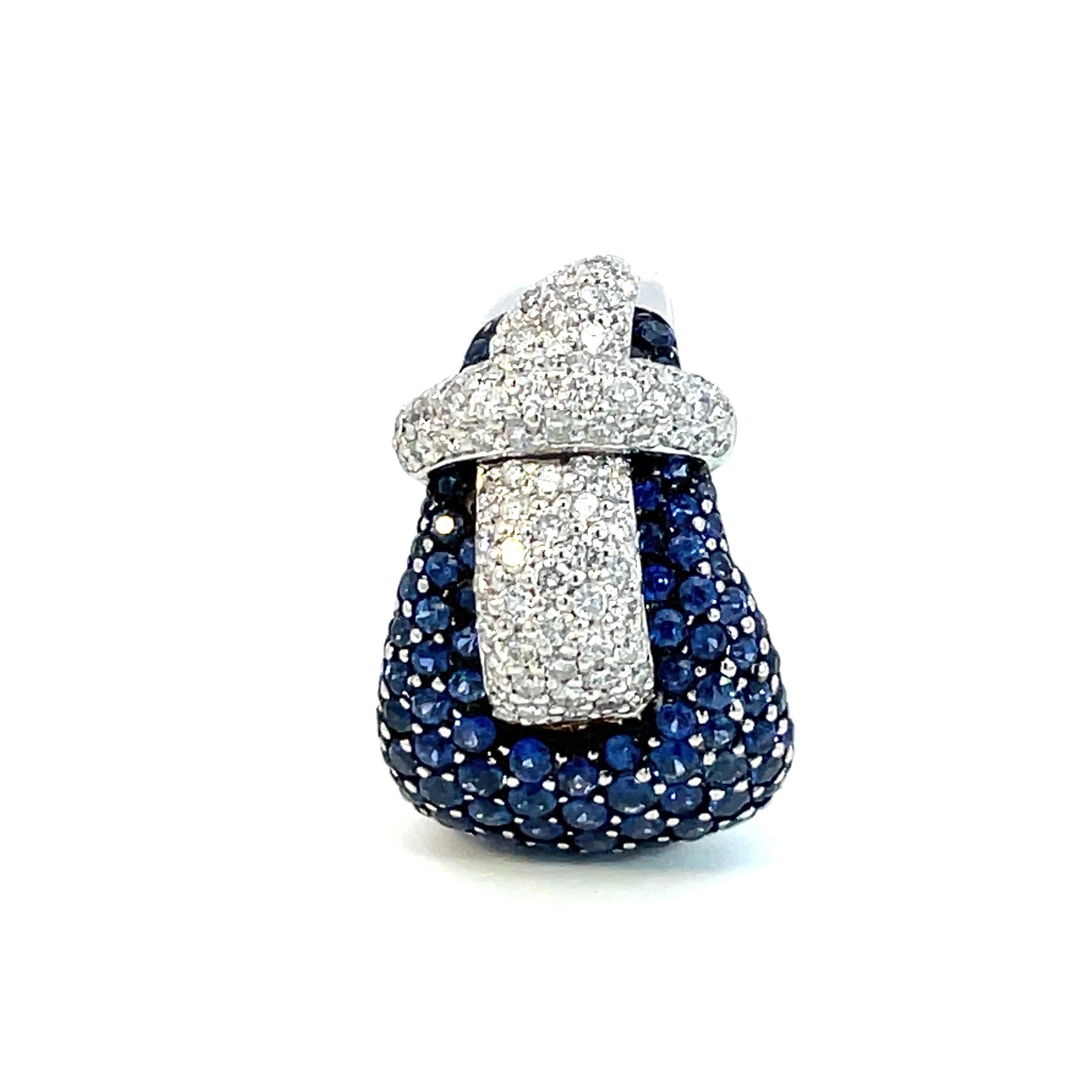 One natural blue sapphire and natural diamond Buckle Ring meticulously set with only the deepest blue sapphires and finest quality brilliant cut diamonds.

98 round cut natural blue sapphires weighing 3.40ct total weight

80 brilliant cut diamonds