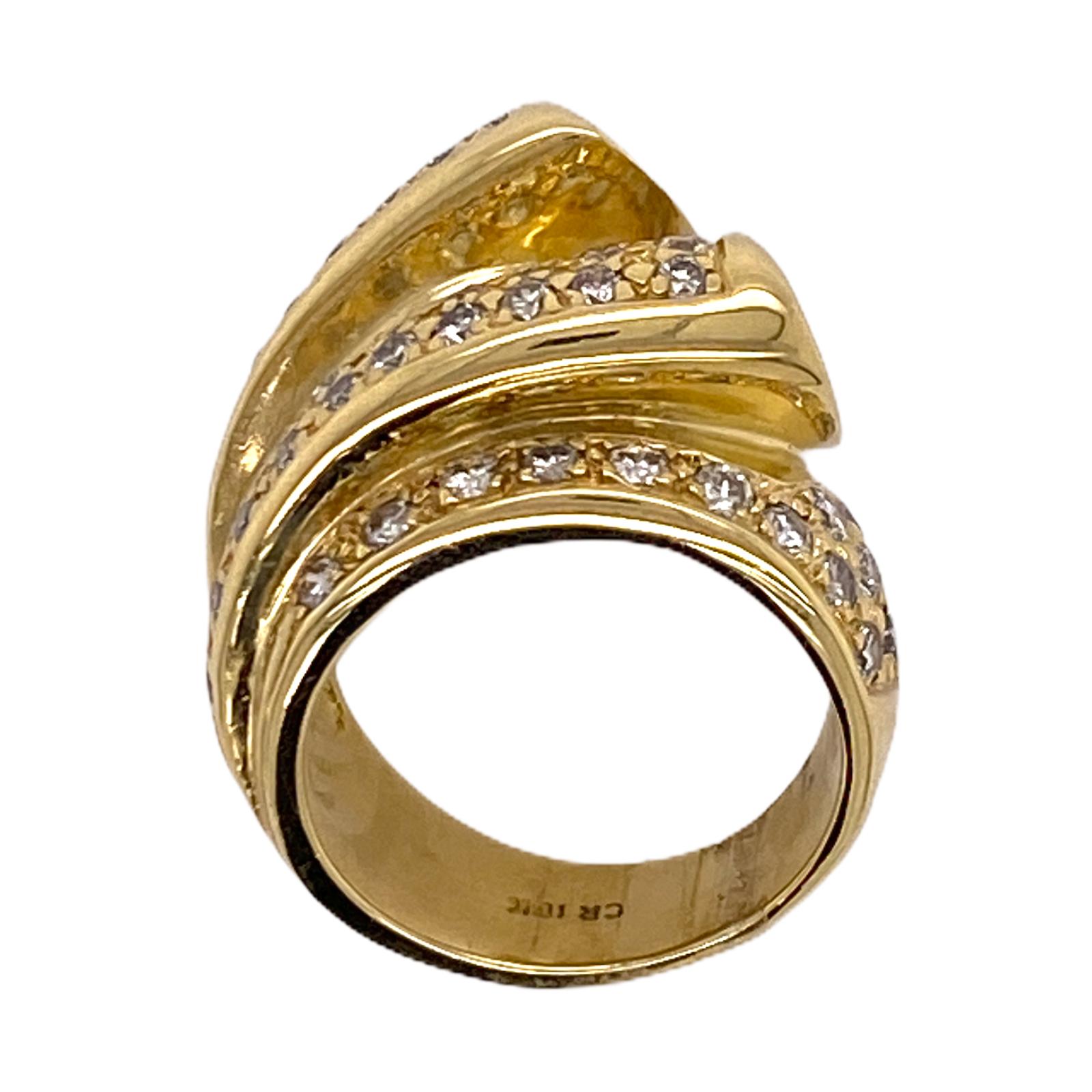 Fabulous pave diamond ribbon ring fashioned in 18 karat yellow gold. The ring features round brilliant cut diamonds weighing 1.20 carat total weight and graded H-I color and SI clarity. The ring measures .75 inches in width and is currently size 5