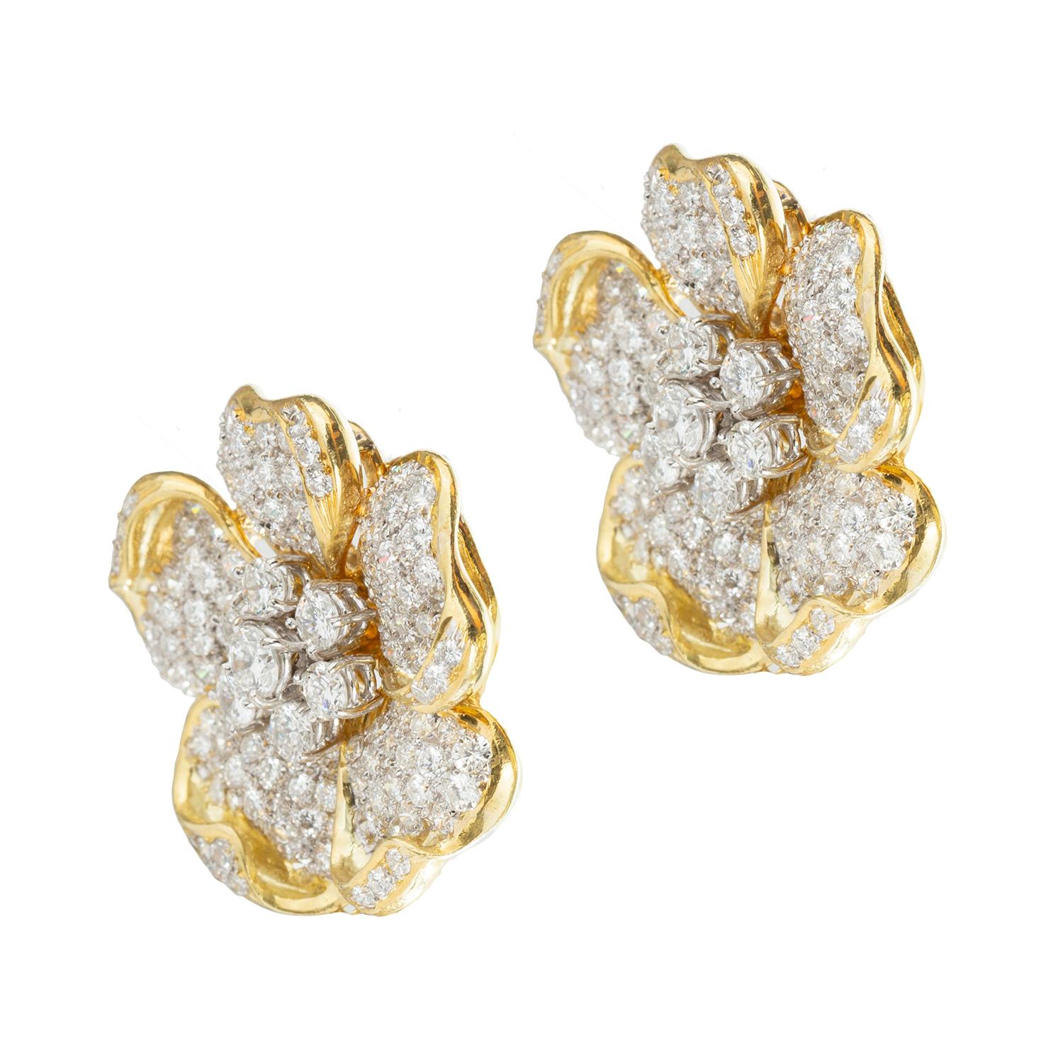 Flower motif earrings in 18k yellow and white gold pave-set with round brilliant-cut diamonds.  Diamonds weighing approximately 10 total carats.  Clip backs (posts may be added upon customer request).  1.1
