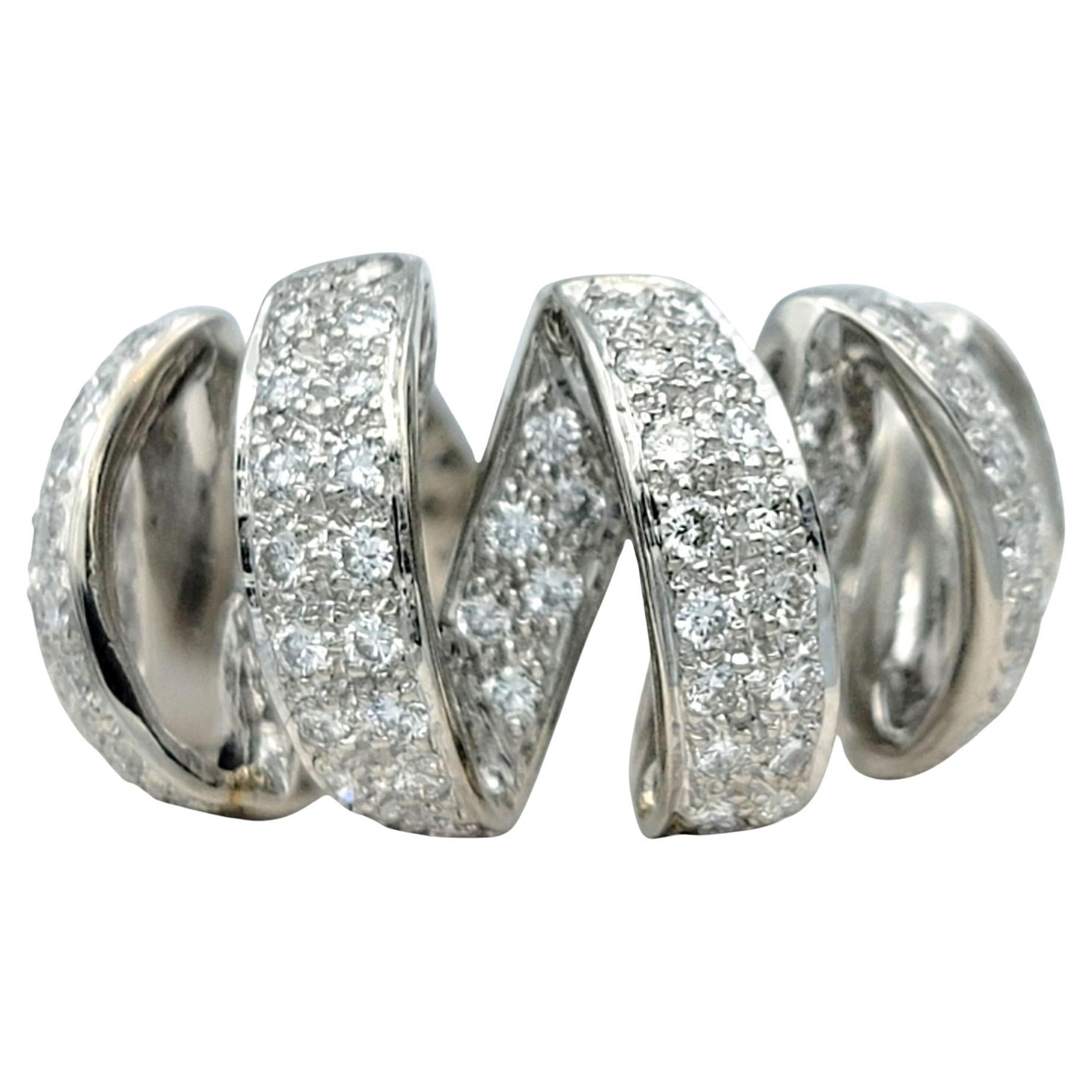 Ring Size: 6

This sculptural diamond ring is designed with flowing platinum ribbons that interlace and curve to create an elegant, dimensional silhouette. At the center of each polished arc, pavé-set round brilliant cut diamonds glisten with