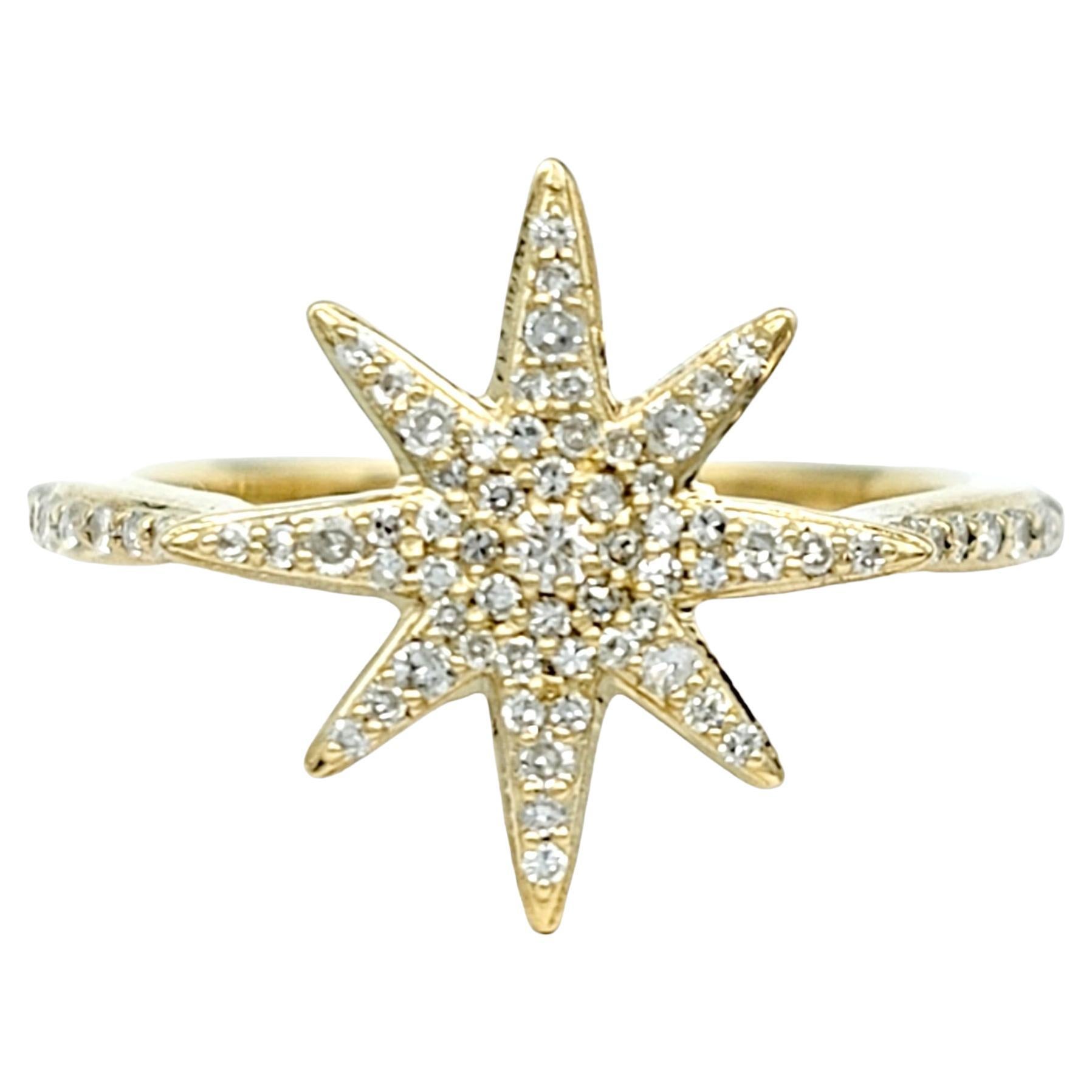 Ring size: 7 

This gorgeous 14 karat yellow gold ring boasts an exquisite design, featuring an captivating 8-point star adorned with pavé-set round white diamonds. This central motif immediately captures the eye with its intricate brilliance,