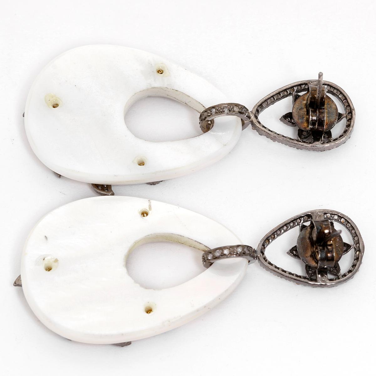 Pave Diamond and Mother of Pearl Dangling Earrings - . Oval shaped Mother of Pearl earrings. Set in 9 grams of Sterling Silver with decorative flower diamonds. Total diamond weight 2.6 cts. Total weight 19.8 grams.