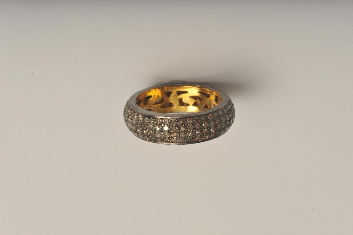 Pave` Diamonds are set all along the exterior of this band, set in oxidized sterling silver and 18K gold (weighted) inside.  Diamond weight is 1.4 carats.  Ring size is 7.5
