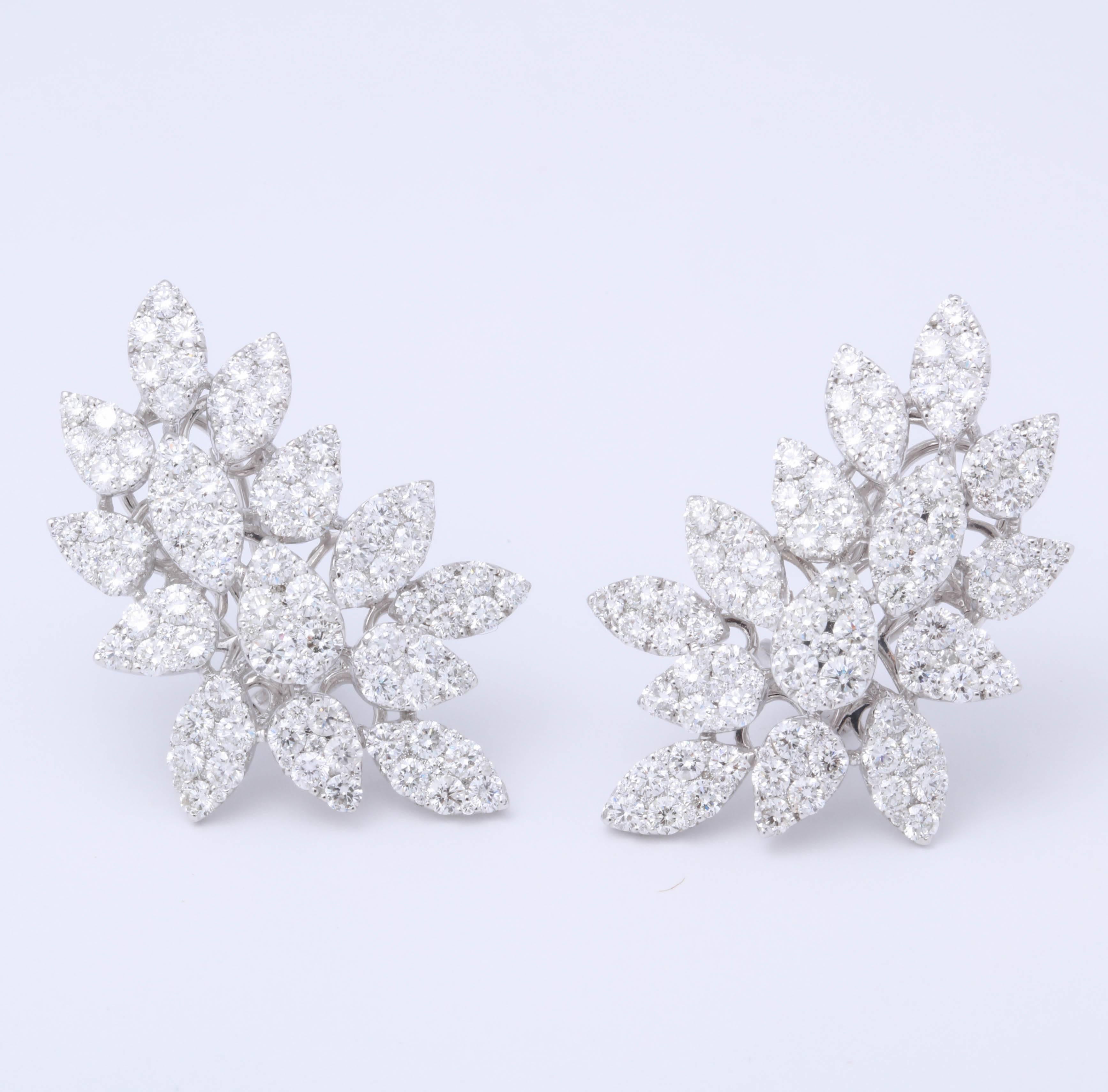 
A grand pair of cluster earrings -- full of sparkle!!

6.58 carats of white round brilliant cut diamonds set in marquise and pear shapes. 

18k white gold 

Approximately 1.4 inches in length from the highest to lowest point, .95 inches at its