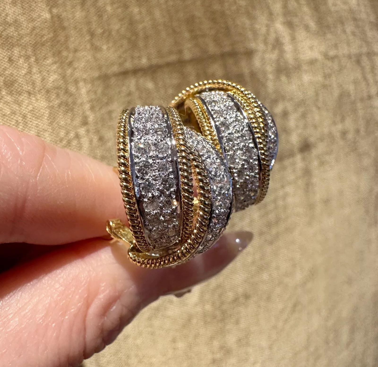 Pave Diamond Crossover Earrings in 18k Yellow Gold 

Diamond Earrings feature two Curved Bands of Round Brilliant Diamonds set in pave style in a Crossover Design with Milgrained edges, all set in 18k Yellow Gold. The earrings are secured by posts